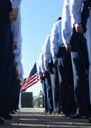 Members of the 747th Communications Squadron stand at attention prior to a Reveille ceremony on Joint Base Pearl Harbor-Hickam, Hawaii, July 2, 2015. The ceremony was held to honor the upcoming Fourth of July holiday. This year the United States of America celebrates 239 years of independence.  (U.S. Air Force photo by Tech. Sgt. Aaron Oelrich by Released)  