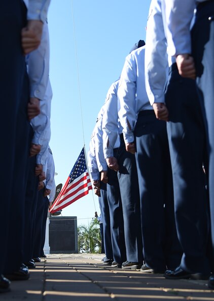 Members of the 747th Communications Squadron stand at attention prior to a Reveille ceremony on Joint Base Pearl Harbor-Hickam, Hawaii, July 2, 2015. The ceremony was held to honor the upcoming Fourth of July holiday. This year the United States of America celebrates 239 years of independence.  (U.S. Air Force photo by Tech. Sgt. Aaron Oelrich by Released)  