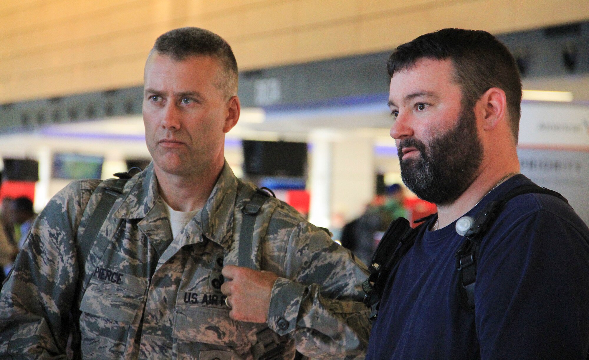 From left, Master Sgt. Chris Pierce, from the 446th Security Forces Squadron, talks with Doug Houseman, Boeing employee and 446th SFS retiree, after processing a ticketing counter at Seattle-Tacoma International Airport July 1. Pierce left Washington as part of a mass deployment across Southwest Asia in support of the Global War on Terrorism. Housemna, as well as several Reservists from the 446th Airlift Wing accompanied the team to the airport for moral support. By the Fourth of July, more than 40 personnel from the squadron will be deployed. (Courtesy photo by Kevin Iriarte)