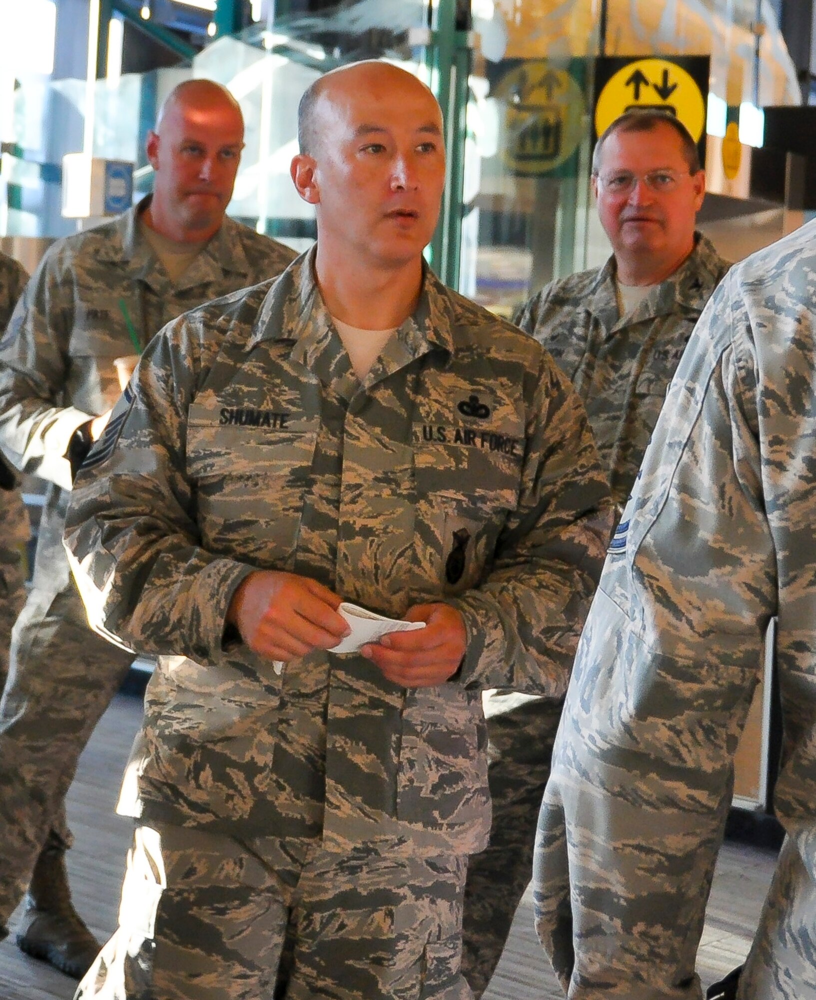 Master Sgt. Rick Shumate (front, center), 446th Security Forces Squadron Alpha Flight chief, talk to a few members from his squadron after processing a ticketing counter at Seattle-Tacoma International Airport July 1. Shumate left Washington as part of a mass deployment across Southwest Asia in support of the Global War on Terrorism. Several Reservists from the 446th Airlift Wing, including Master Sgt. Michael Pate (rear, left), from the 446th SFS, and Col. Bryan Runion, 446th Mission Support Group commander (rear, right), accompanied the team to the airport for moral support. (U.S. Air Force Reserve photo by Master Sgt. Minnette Mason)