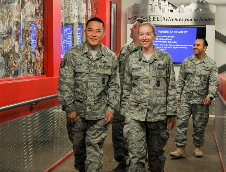 Tech. Sgts. Peter Ahn, Beth Parker-Henderson (front), Daniel Carroll (middle), and Alexis Flores, all members of the 446th Security Forces Squadron, walk up a ramp of USO Northwest SeaTac Center at Seattle-Tacoma International Airport July 1. All four 446th SFS personnel left Washington as part of a mass deployment across Southwest Asia in support of the Global War on Terrorism. By the Fourth of July, more than 40 personnel from the squadron will be deployed. (U.S. Air Force Reserve photo by Master Sgt. Minnette Mason)
