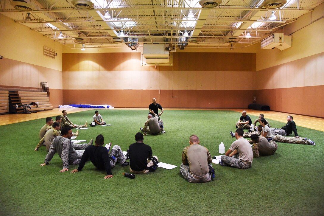 Students of the Combatives Instructor Course watch as an instructor teaches proper technique for one of the many hand-to-hand combatives moves they learned throughout the program at the Malmstrom Air Force Base fitness center June 30. The class, as well as future classes, may be attended by any security forces personnel. (U.S. Air Force photo/Airman 1st Class Collin Schmidt)