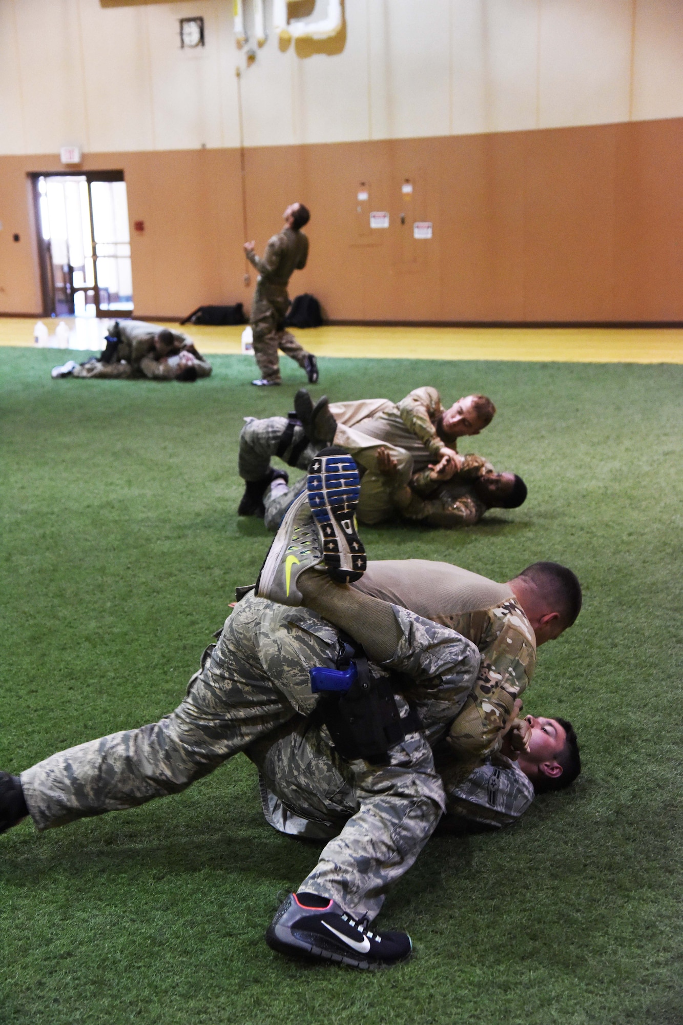 Members of the 341st Security Forces Group at Malmstrom Air Force Base spar during a Combatives Instructor Course at the base’s fitness center June 30. The course focuses on weapons retention, suspect control and challenge techniques, and close-quarter hand-to-hand combative technique. (U.S. Air Force photo/Airman 1st Class Collin Schmidt)
