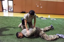 Airman 1st Class Sheristy DeJesus, 741st Missile Security Forces Squadron member (top), pins her training partner Senior Airman Michael Staley, 341st Security Forces Group Tactical Response Force member, during the Combatives Instructor Course at the Malmstrom Air Force Base fitness center June 30. The course was designed to teach Airmen close-quarter hand-to-hand combat techniques. (U.S. Air Force photo/Airman 1st Class Collin Schmidt) 