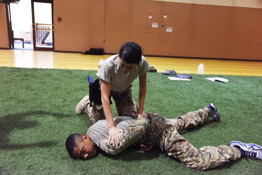 Airman 1st Class Sheristy DeJesus, 741st Missile Security Forces Squadron member (top), pins her training partner Senior Airman Michael Staley, 341st Security Forces Group Tactical Response Force member, during the Combatives Instructor Course at the Malmstrom Air Force Base fitness center June 30. The course was designed to teach Airmen close-quarter hand-to-hand combat techniques. (U.S. Air Force photo/Airman 1st Class Collin Schmidt) 