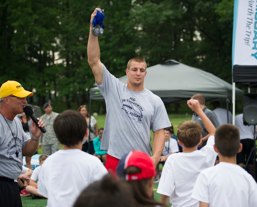 Rob Gronkowski, New England Patriots tight end, hands out medals at the end of a football camp held on Joint Base Andrews, Md., July 1-2, 2015. Gronkowski, a three-time Pro Bowler and Super Bowl XLIX champion, coached approximately 100 military children during the two-day event. (U.S. Air Force photo/Tech. Sgt. Robert Cloys)