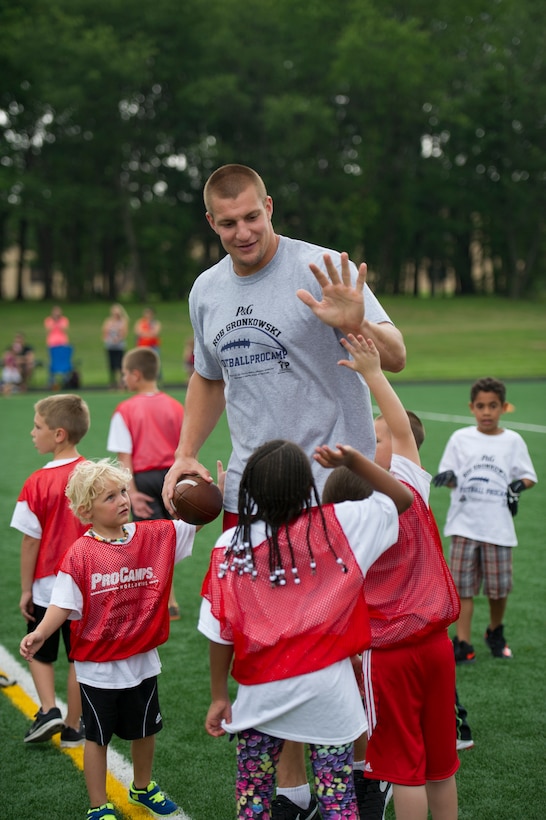 Rob Gronkowski, New England Patriots tight end, high-fives his team during a football camp on Joint Base Andrews, Md., July 2, 2015. Gronkowski, a three time Pro Bowler and Super Bowl XLIX champion, coached approximately 100 military children during the two-day camp. (U.S. Air Force photo/Tech. Sgt. Robert Cloys)