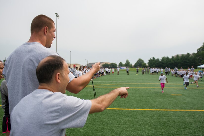 Rob Gronkowski, New England Patriots tight end, clocks sprint times during a race at a ProCamps event on Joint Base Andrews, Md., July 2, 2015. Gronkowski, a three time Pro Bowler and Super Bowl XLIX champion, coached approximately 100 military children during the two-day football camp. (U.S. Air Force photo/Tech. Sgt. Robert Cloys)