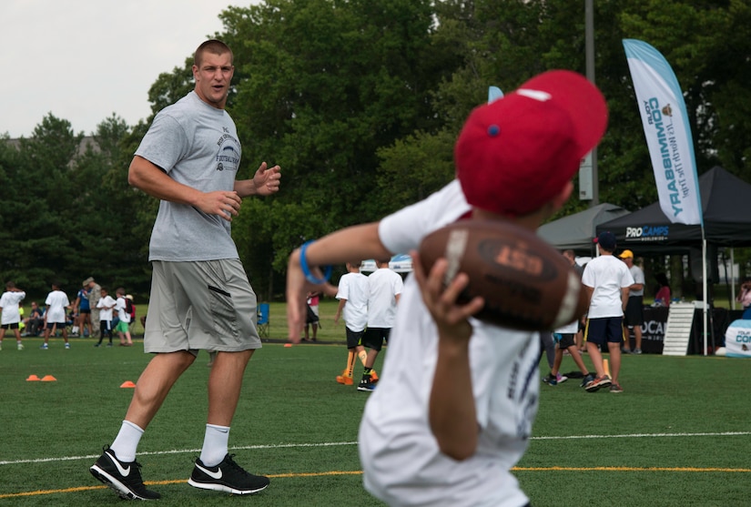 Rob Gronkowski, New England Patriots tight end, runs a route while a camper throws him a pass during a ProCamps event on Joint Base Andrews, Md., July 1, 2015. Gronkowski, a three time Pro Bowler and Super Bowl XLIX champion, coached approximately 100 kids during the two day camp. (U.S. Air Force photo/Airman 1st Class Philip Bryant)