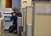 A member of the Joint Base Pearl Harbor-Hickam security department secures the area while a suspect is apprehended during an active-shooter exercise, held July 1, 2015 off-base at the Personnel Support Detachment Building. The exercise tested the JBPHH security department and HPD's response capabilities during an active shooter scenario. (U.S. Air Force photo by Senior Airman Christopher Stoltz/Released)