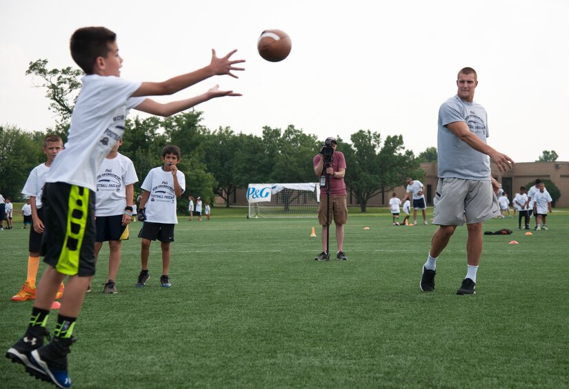 Rob Gronkowski, New England Patriots tight end, throws to a camper during a ProCamps event on Joint Base Andrews, Md., July 1, 2015. Gronkowski ran through football drills at multiple stations teaching campers how to run routes and catch a football. (U.S. Air Force photo/Airman 1st Class Philip Bryant)