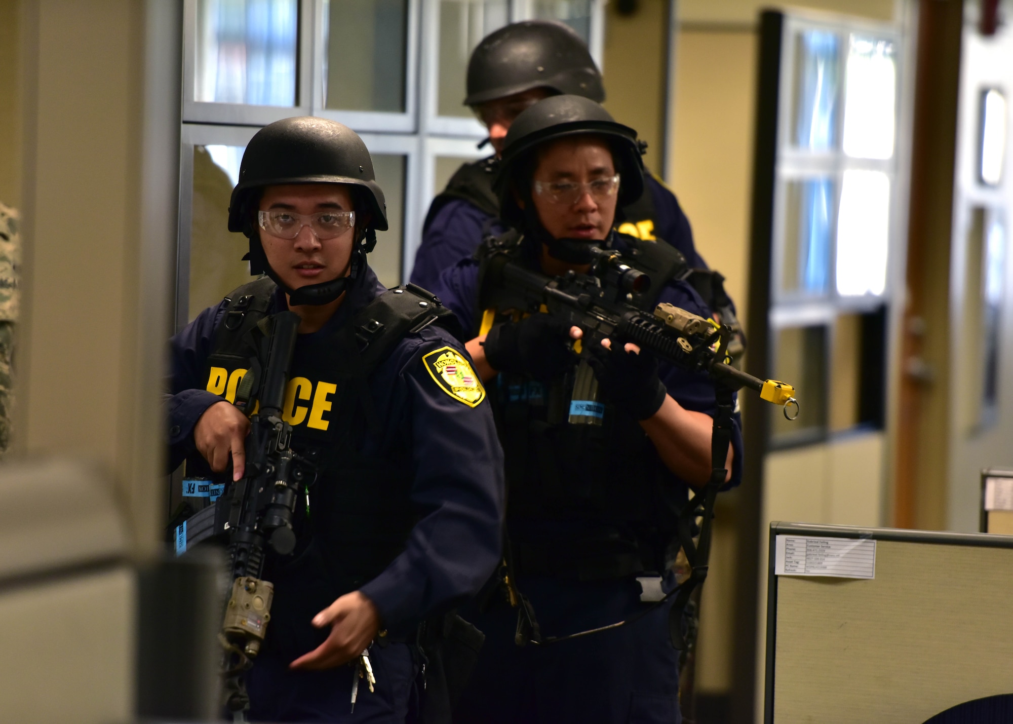 Officers from the Honolulu Police Department arrive on-scene and clear the area during an active-shooter exercise, held July 1, 2015 off-base at the Personnel Support Detachment Building. The exercise tested the JBPHH security department and HPD's response capabilities during an active shooter scenario. (U.S. Air Force photo by Senior Airman Christopher Stoltz/Released)