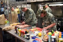 Master Sgt. Micheal Filipovich, right, 341st Missile Security Forces Squadron first sergeant, and Master Sgt. Jeffery House, 341st Medical Group first sergeant, participate in the Warrior Chef Challenge  June 30, 2015, at Malmstrom Air Force Base, Mont.  The Warrior Chef Challenge is an on-going tradition of the food services career field. (U.S. Air Force photo/Chris Willis)