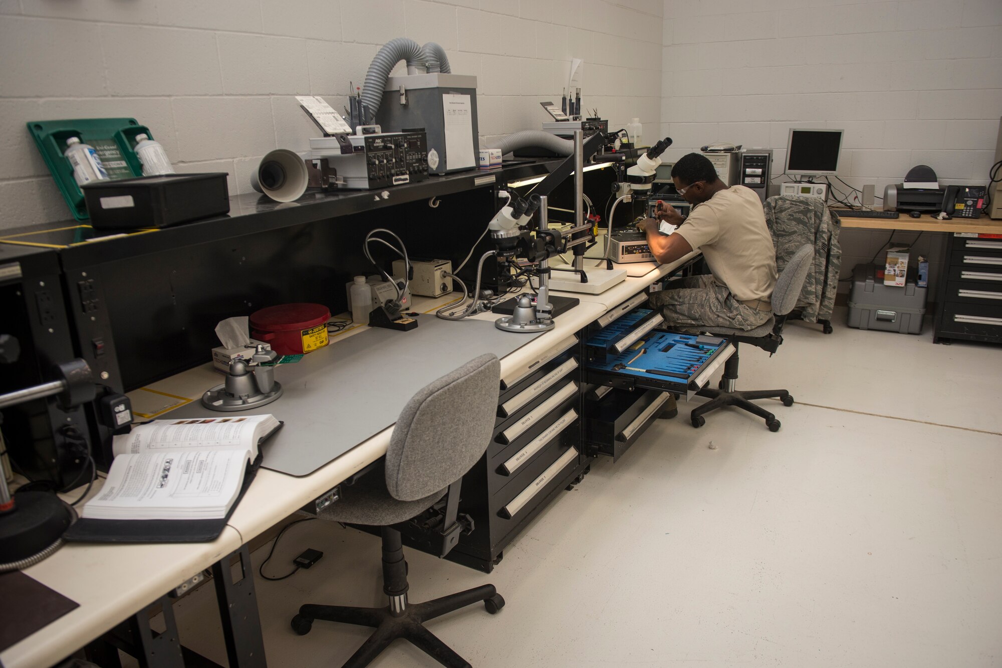 Staff Sgt. Mark Hawkins, Air Force Repair Enhancement Program lead technician, removes the case from a projector to assess the malfunction and conduct the repair at Holloman Air Force Base, N.M., July 1, 2015. In less than a year, Hawkins has saved Holloman $176,000 in avoidance by conducting repairs in house as opposed to having a replacement purchased. (U.S. Air Force photo by Senior Airman Aaron Montoya / Released)