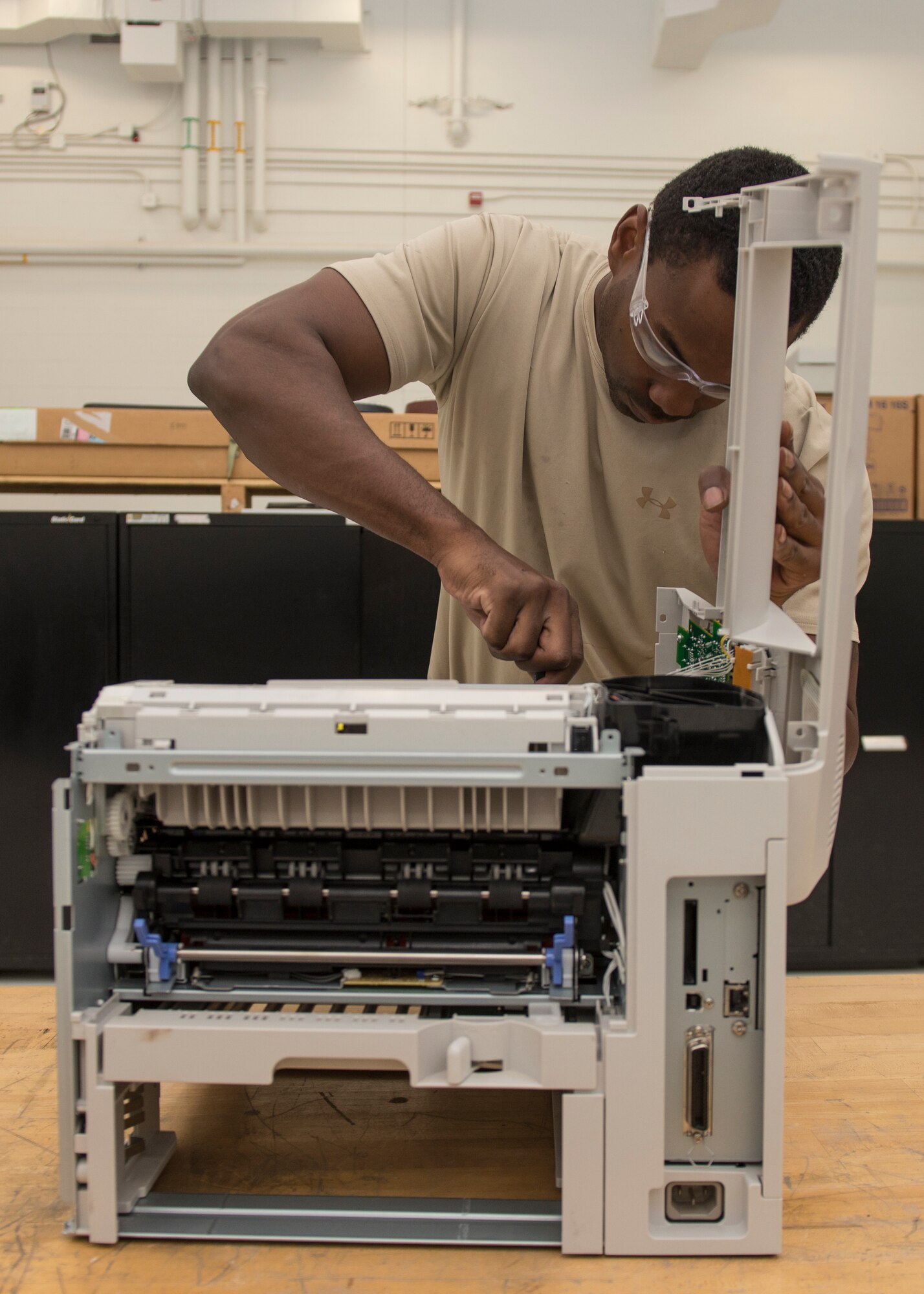Staff Sgt. Mark Hawkins, Air Force Repair Enhancement Program lead technician, repairs a malfunctioning printer to avoid the cost of replacing the part at Holloman Air Force Base, N.M., July 1, 2015. AFREP saves the Air Force money by avoiding the cost of replacing malfunctioning equipment or hiring contractors to perform the repair. That goes for printers, shredders, gym equipment and more. It’s not just flight line stuff that they fix, it’s base-wide. (U.S. Air Force photo by Senior Airman Aaron Montoya / Released)