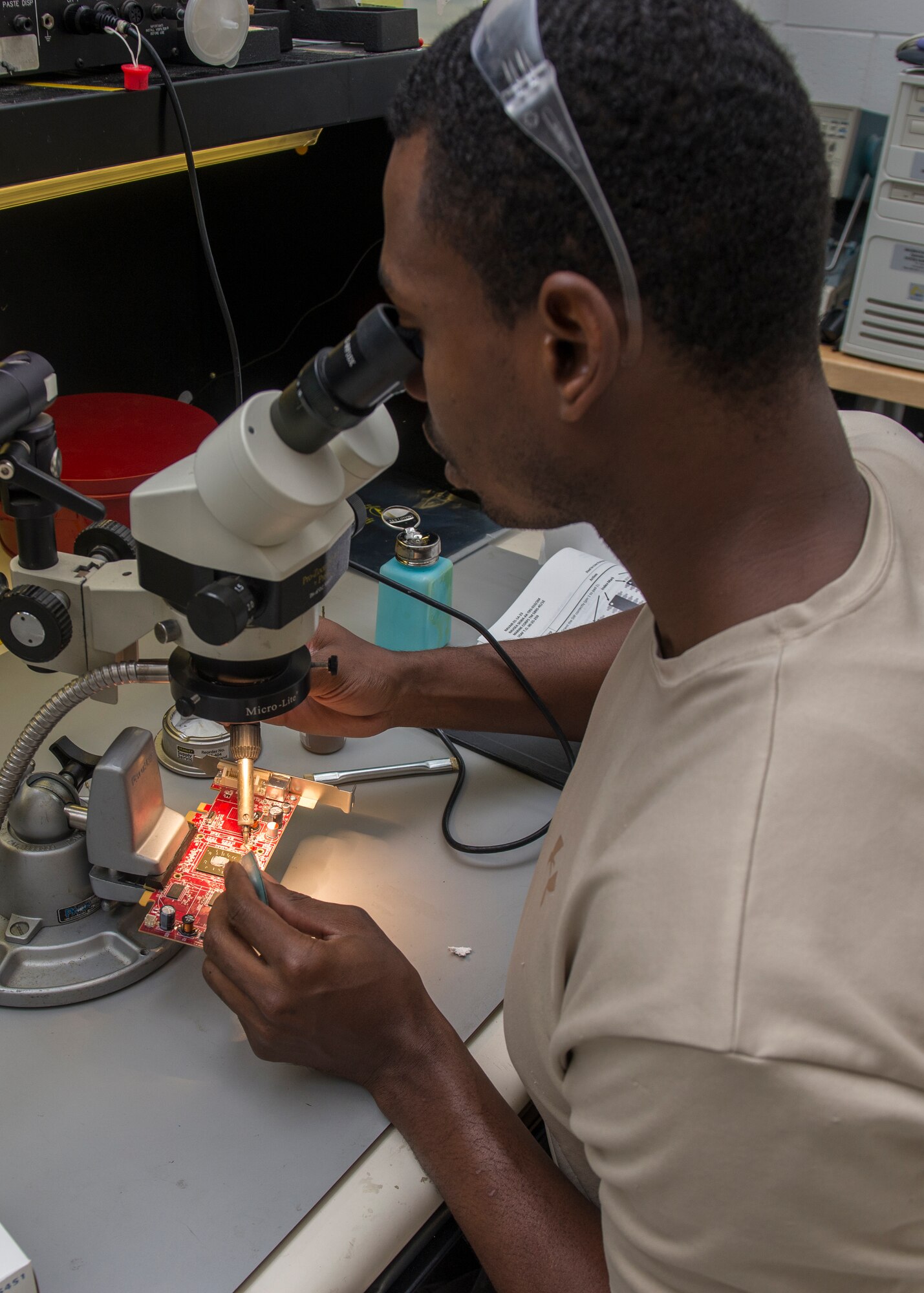 Staff Sgt. Mark Hawkins, Air Force Repair Enhancement Program lead technician, repairs a malfunctioning circuit board to avoid the cost of replacing the part at Holloman Air Force Base, N.M., July 1, 2015. AFREP saves the Air Force money by avoiding the cost of replacing malfunctioning equipment or hiring contractors to perform the repair. In less than a year, Hawkins has saved Holloman over $176,000 by repairing broken equipment. (U.S. Air Force photo by Senior Airman Aaron Montoya / Released)