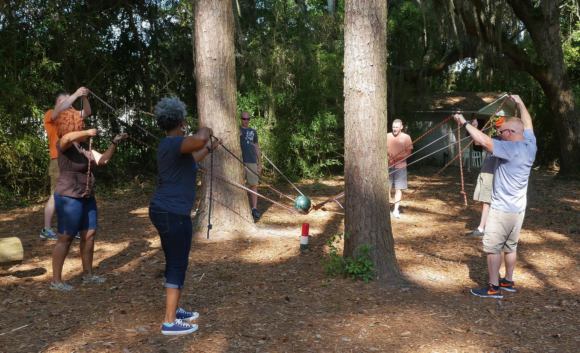 U.S. Airmen with the Georgia Air National Guard, work together during a team building exercise at the outdoor adventure course during the Strong Bonds singles retreat at the Sea Palms Resort, Saint Simons Island, Ga., June 27, 2015. The retreat, hosted by chaplains from the 116th Air Control wing, is a key component of the unit's resiliency program aimed at helping Airmen from Air National Guard units across Georgia to build relationships, learn to trust people, and hone their teambuilding skills. (U.S. Air National Guard photo by Senior Master Sgt. Roger Parsons/Released)