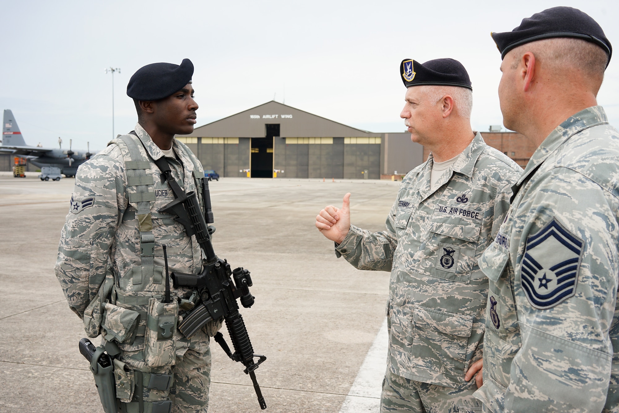 U.S. Air Force Chief Master Sgt. William Greenway, center, 116th Security Forces Squadron (SFS) Manager, questions Airman 1st Class Devajia Saucier, left, while Senior Master Sgt. James Miller, 116th SFS operations superintendent looks on, during a post briefing on the flightline at Joint Base Savannah, Ga., June 23, 2015. The JSTARS cops from the Georgia Air National Guard’s 116th Air Control Wing completed 15 days of law enforcement and flightline security training during their annual tour at Joint Base Savannah. During the training, the security forces Airmen responded to multiple simulated security threats each day and played the role of both cops and aggressors under the watchful eye of evaluators from the unit. (U.S. Air National Guard photo by Senior Master Sgt. Roger Parsons/Released)