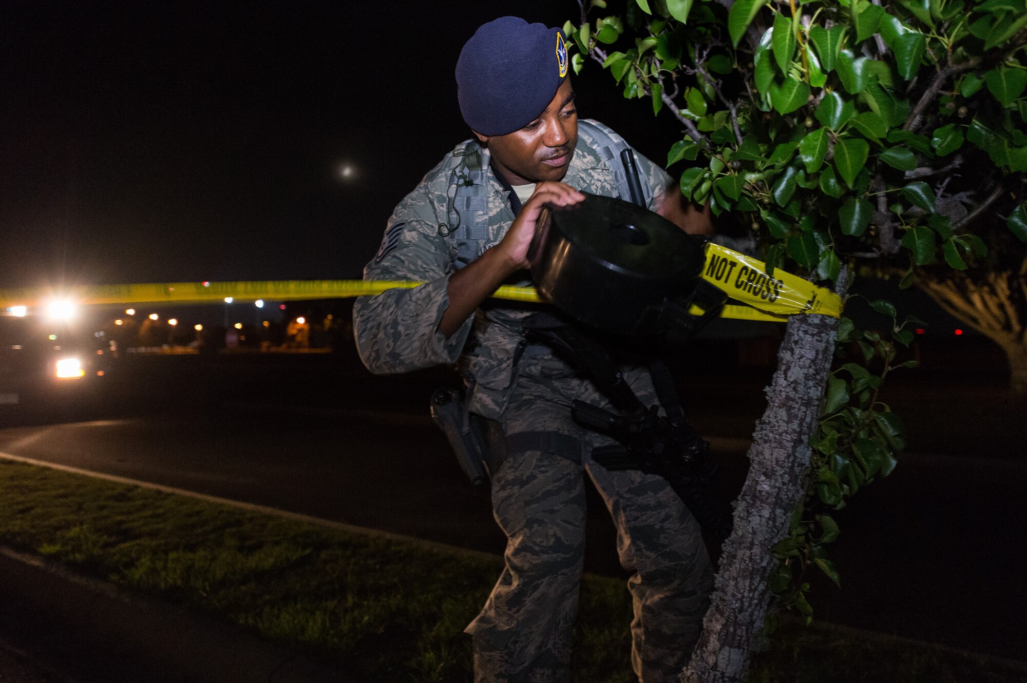 U.S. Air Force Tech. Sgt. Jason Williams, 116th Security Forces Squadron, Georgia Air National Guard, installs crime scene barrier tape around a simulated crime scene during a training exercise at Joint Base Savannah, Ga., June 24, 2015. The JSTARS cops from the Georgia Air National Guard’s 116th Air Control Wing completed 15 days of law enforcement and flightline security training during their annual tour at Joint Base Savannah. During the training, the security forces Airmen responded to multiple simulated security threats each day and played the role of both cops and aggressors under the watchful eye of evaluators from the unit. (U.S. Air National Guard photo by Senior Master Sgt. Roger Parsons/Released)


