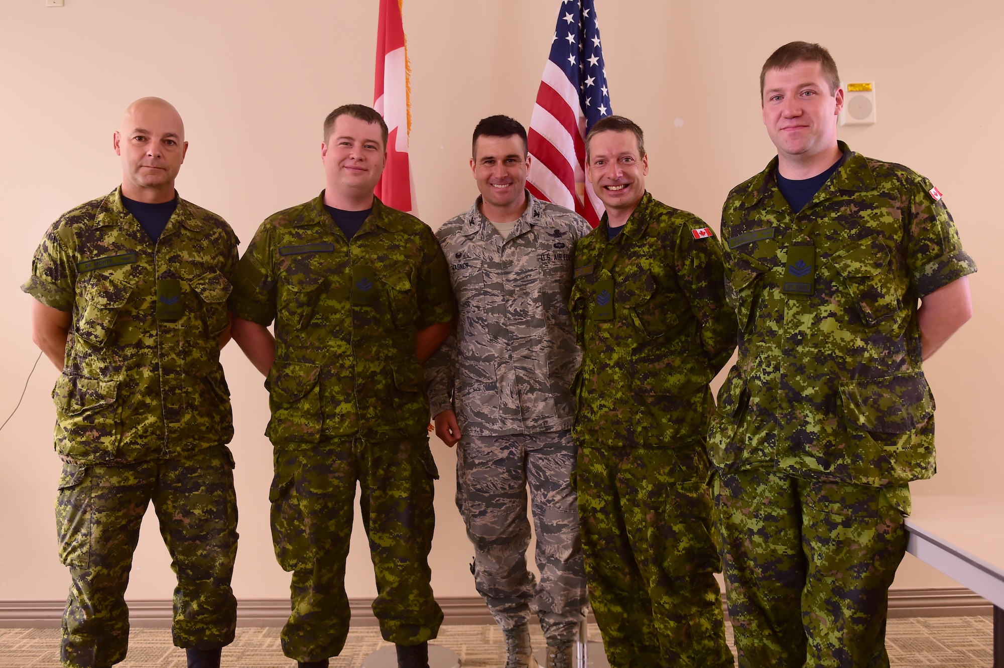 Col. John Wagner, 460th Space Wing commander, stands side-by-side with Canadian service members to recognize Canada Day at the Buckley Chapel Fellowship Luncheon July 1, 2015, on Buckley Air Force Base, Colo. Wagner spoke on the history of Canada Day and stated the importance of the United States’ alliance with Canada. (U.S. Air Force photo by Airman 1st Class Luke W. Nowakowski/Released)
