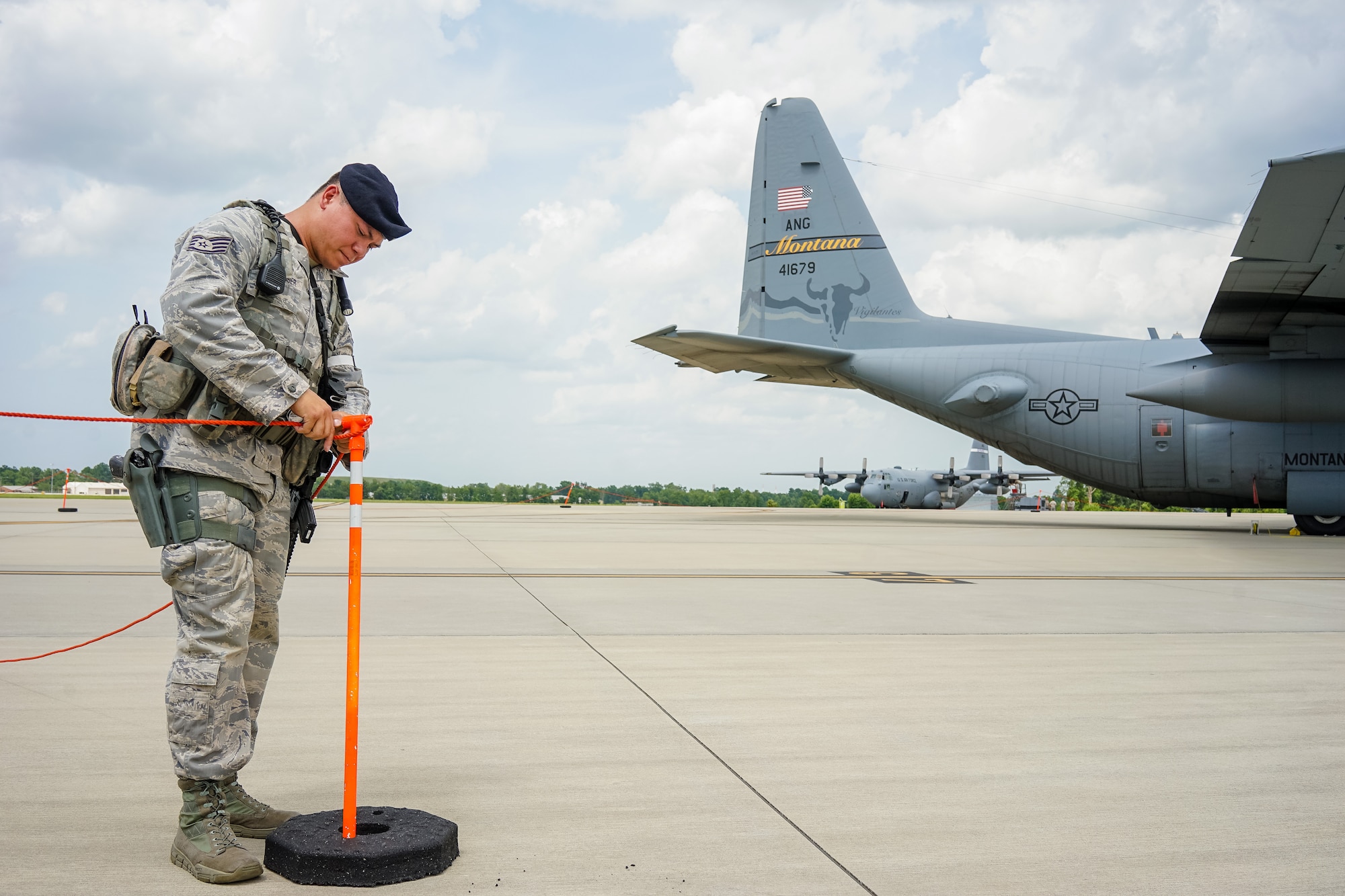 U.S. Air Force Staff Sgt. Hai Spletstoser, 116th Security Forces Squadron, Georgia Air National Guard, ropes off a restricted area around a C-130 Hercules during a training exercise at Joint Base Savannah, Ga., June 25, 2015. The JSTARS cops from the Georgia Air National Guard’s 116th Air Control Wing completed 15 days of law enforcement and flightline security training during their annual tour at Joint Base Savannah. During the training, the security forces Airmen responded to multiple simulated security threats each day and played the role of both cops and aggressors under the watchful eye of evaluators from the unit. (U.S. Air National Guard photo by Senior Master Sgt. Roger Parsons/Released)

