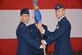 Col. Michael J. Homola, 552nd Air Control Group commander, left, passes the guidon to Maj. Victor R. Norris as the major assumes command of the 552nd Air Control Network Squadron during a ceremony June 26 in Bldg. 230. Major Norris replaces Lt. Col. Nicholas T. Kozdras, who is headed to Air Combat Command. Major Norris comes to Tinker Air Force Base having served as the lead cyberspace operations planner at North America Aerospace Defense Command and U.S. Northern Command. Colonel Homola presided over the ceremony. (Air Force photo by Darren D. Heusel/Released)