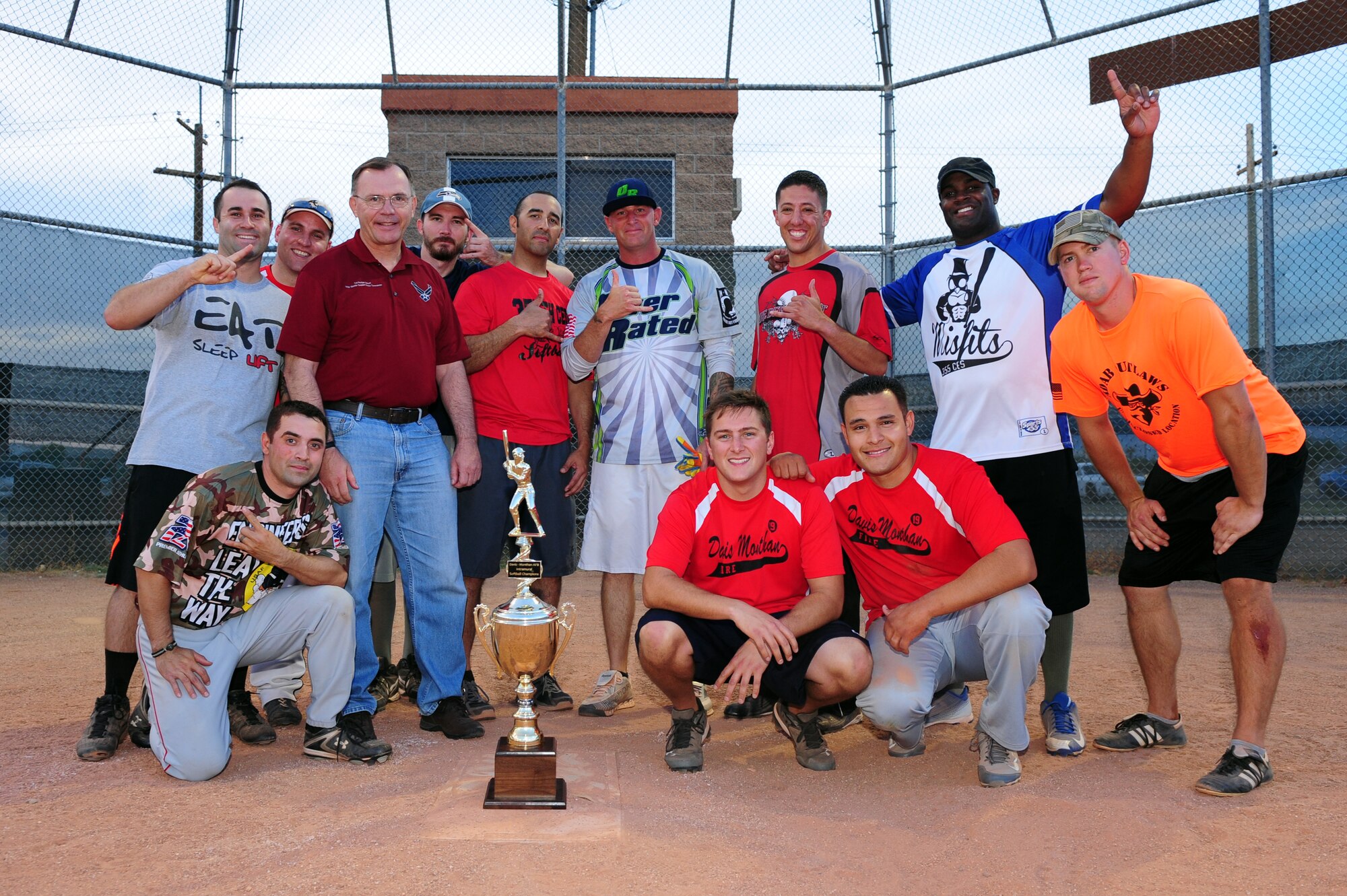The 355th Civil Engineering Squadron intramural softball team poses with Col. Rodger Schuld, 355th Mission Support Group commander, after winning the Intramural Softball Championship game against the 355th Equipment Maintenance Squadron at Davis-Monthan Air Force Base Ariz., July 1, 2015. The 355th CES team went on to defeat 355th EMS 13-12 in extra innings. (U.S. Air Force photo by Airman 1st Class Chris Drzazgowski/Released)