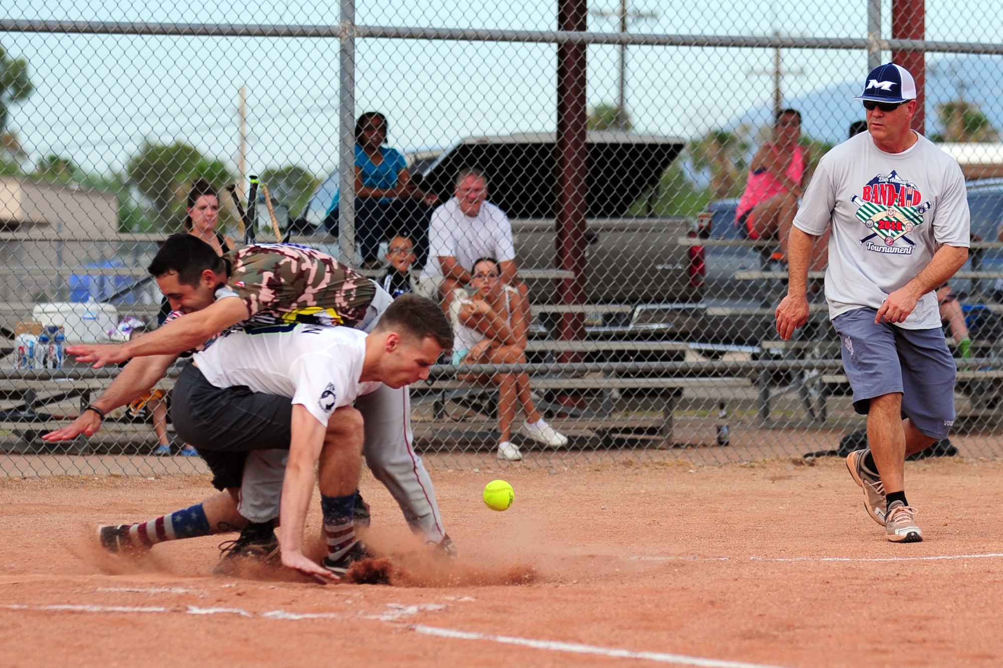 U.S. Air Force Master Sgt. Adam Boubede, 355th Civil Engineering Squadron electrical systems craftsman, collides with the 355th Equipment Maintenance Squadron’s catcher during the Intramural Softball Championship game at Davis-Monthan Air Force Base Ariz., July 1, 2015. The 355th EMS began trailing 4-1, and then went on a run streak that put them ahead of the 355th CES 10-4, but lost in extra innings 13-12. (U.S. Air Force photo by Airman 1st Class Chris Drzazgowski/Released) 