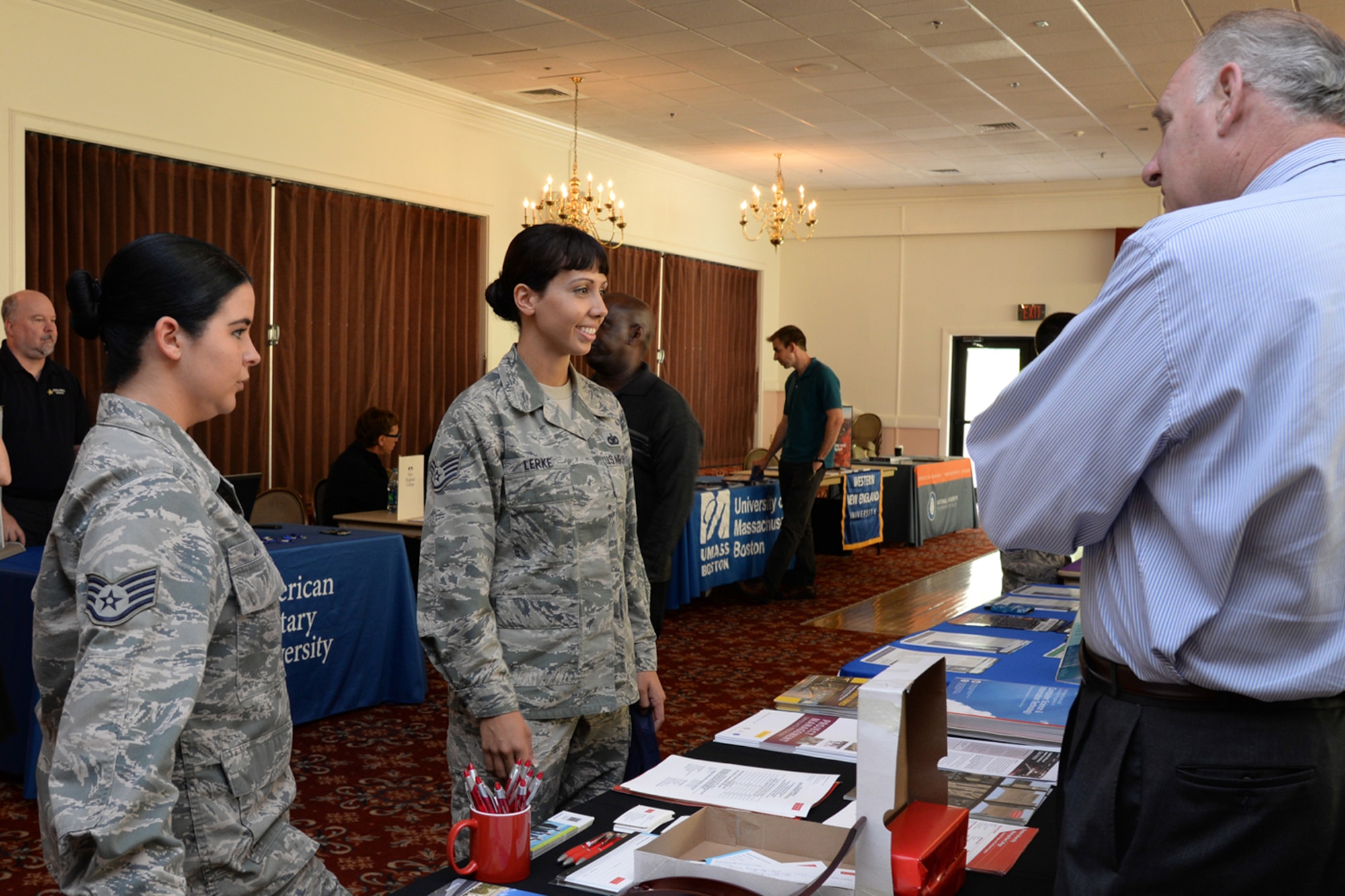 Staff Sgt. Alesha James, left, and Staff Sgt. Ashley Lerke, both Airman Leadership School instructors, speak with J. Gerard Keegan, director of Metropolitan College Programs at Hanscom AFB, during the Education Fair at the Minuteman Commons June 26. The fair provided attendees a single point of access to in-residence and distance learning programs available at local and national colleges and universities. (U.S. Air Force photo by Linda LaBonte Britt)