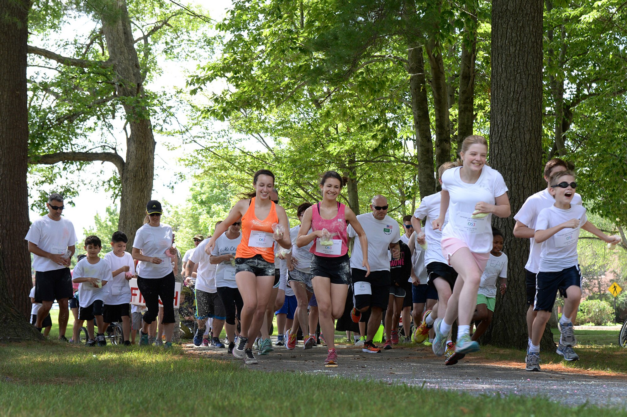 Runners participate in the Network 5/6 Color Run June 26 on base as part of a fundraiser hosted by the Network 5/6 professional organization for the Boston Children's Hospital Cancer Ward. The Color Run is a 5k paint race that is inspired by the Hindu festival of Holi. The event was open to all ages. (U.S. Air Force photo by Linda LaBonte Britt)