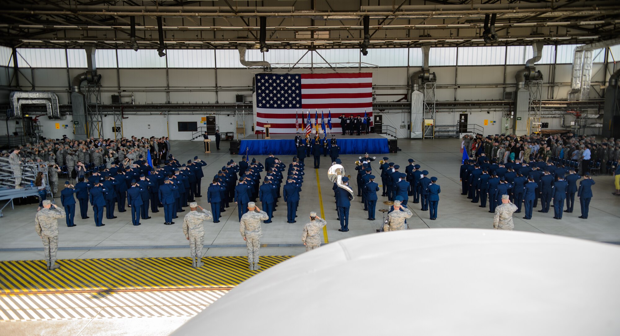 Airmen from the Third Air Force salute as the U.S. Air Force in Europe and Air Forces Africa band plays the national anthem July 2, 2015, at Ramstein Air Base, Germany. Lt. Gen. Timothy Ray took command of the Third Air Force and 17th Expeditionary Air Force during the change of command. (U.S. Air Force photo/ Staff Sgt. Armando A. Schwier-Morales)