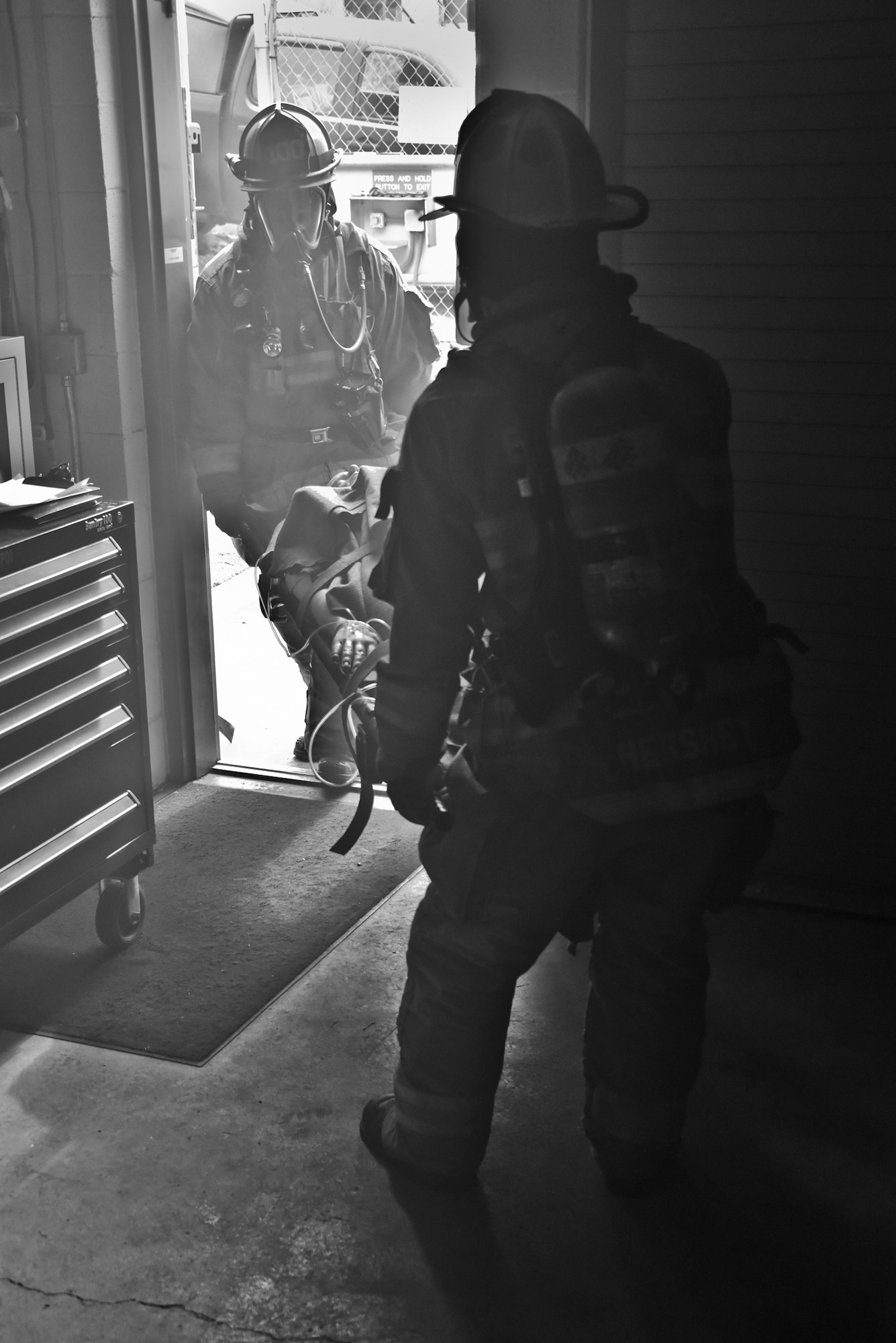 Allegheny County Airport Authority firefighters carry a dummy on a litter away from a simulated burning building during a Major Accident Response Exercise held at Pittsburgh International Airport Air Reserve Station, Pa, June 30, 2015. The MARE simulated lightning striking a building on base, catching it on fire and tested the response time of emergency crews. (U.S. Air Force photo by Senior Airman Joshua J. Seybert)