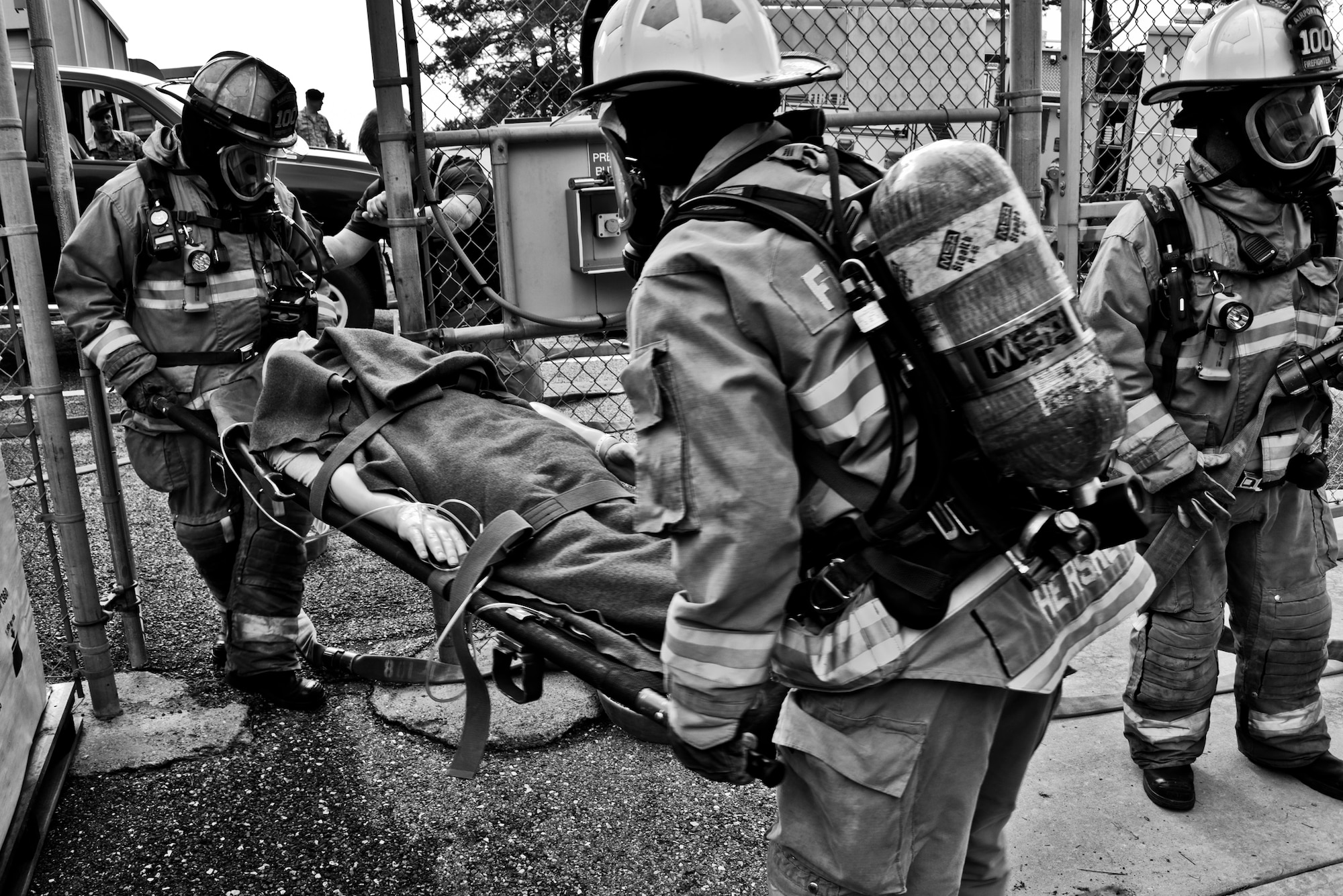 Allegheny County Airport Authority firefighters carry a dummy on a litter away from a simulated burning building during a Major Accident Response Exercise held at Pittsburgh International Airport Air Reserve Station, Pa, June 30, 2015. The MARE simulated lightning striking a building on base, catching it on fire and tested the response time of emergency crews. (U.S. Air Force photo by Senior Airman Joshua J. Seybert)