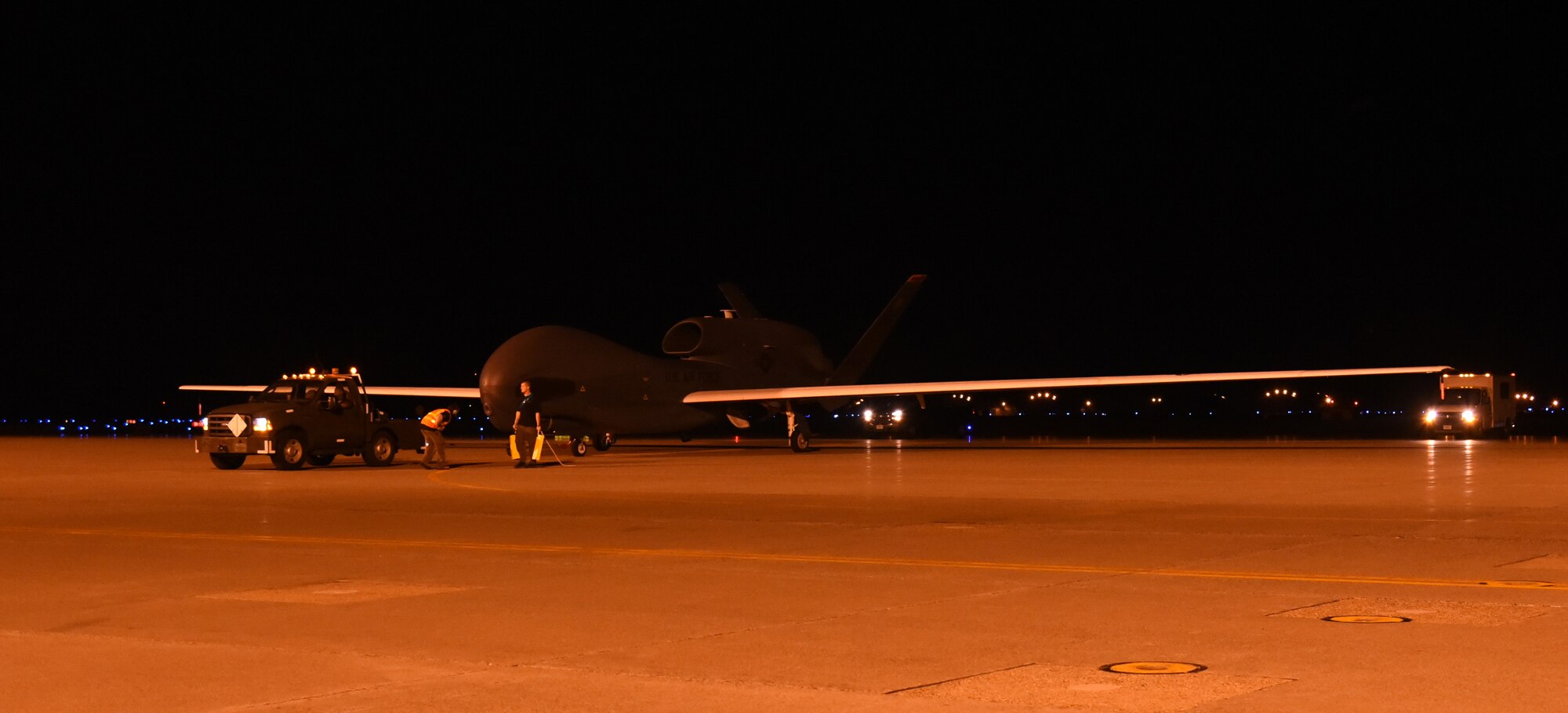 An RQ-4 Global Hawk is towed off the runway after landing at Misawa Air Base, Japan, July 2, 2015. This is one of several Global Hawks to arrive at Misawa for a summer to winter rotation. The aircraft will begin local area checks before its first operational flight in early July. (U.S. Air Force photo by Staff Sgt. Alyssa C. Gibson)