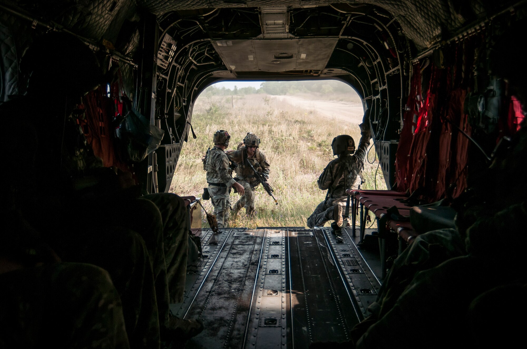 U.S. Air Force Joint Terminal Attack Controllers (JTAC) with the 118th Air Support Operations Squadron (ASOS), North Carolina Air National Guard and the 148th ASOS, Pennsylvania Air National Guard board an Army CH-47 Chinook helicopter assigned to the 2nd Battalion, 238th Aviation Regiment, Illinois Army National Guard during Northern Strike 2014 near Grayling, Mich., Aug. 9, 2014. Northern Strike is an Air National Guard-sponsored training exercise emphasizing air-to-ground operations intended to prepare personnel to conduct direct combat operations. (DoD photo by Master Sgt. Scott Thompson, U.S. Air National Guard/Released)