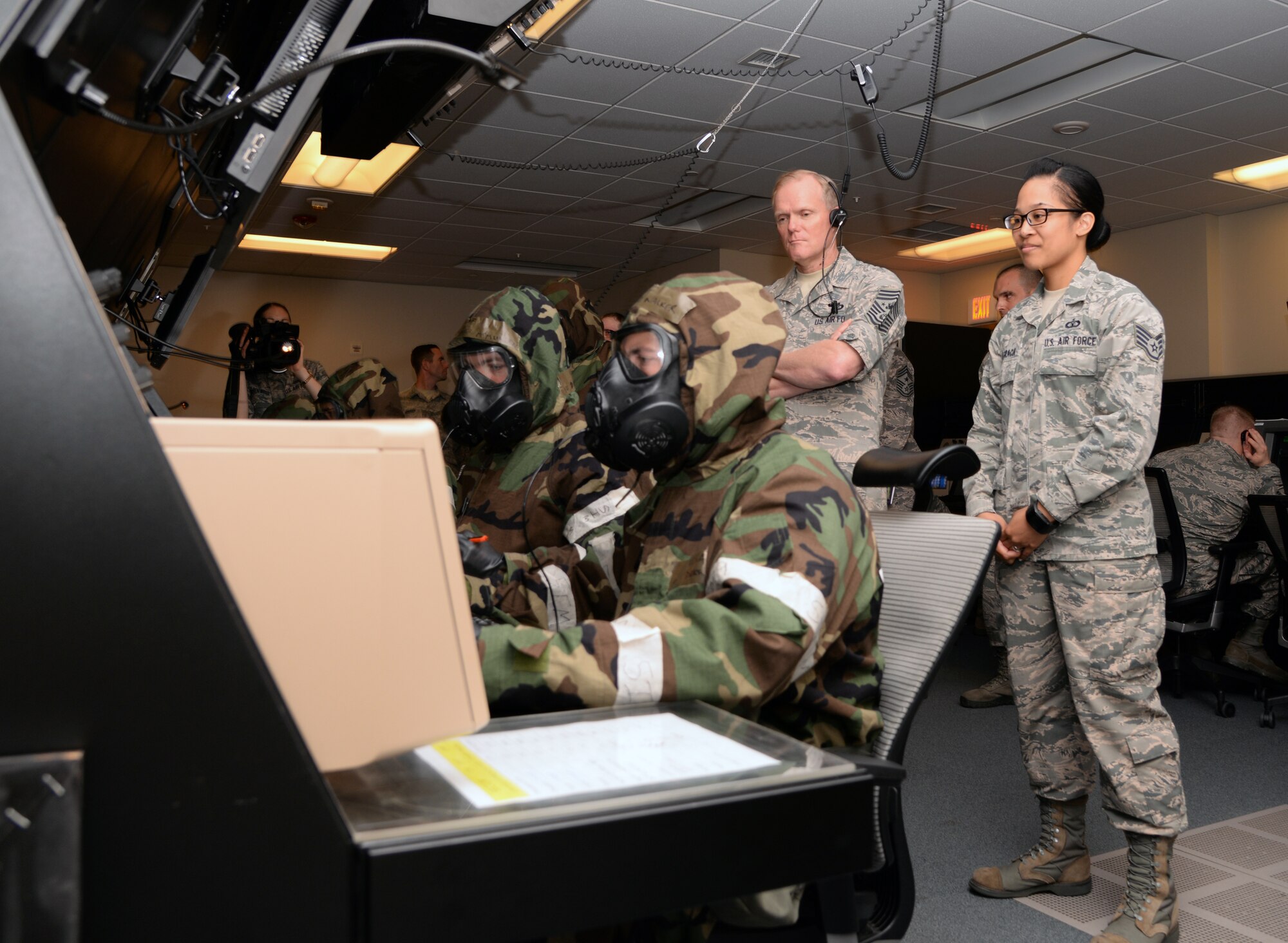 Chief Master Sgt. of the Air Force James Cody, watches air traffic controllers from the 51st Operations Support Squadron demonstrate how they work in simulated chemical environments July 2, 2015, at Osan Air Base, Republic of Korea. Cody was stationed at Osan AB as an air traffic control watch supervisor more than 20 years ago. (U.S. Air Force photo by Staff Sgt.
Benjamin Sutton/Released)
