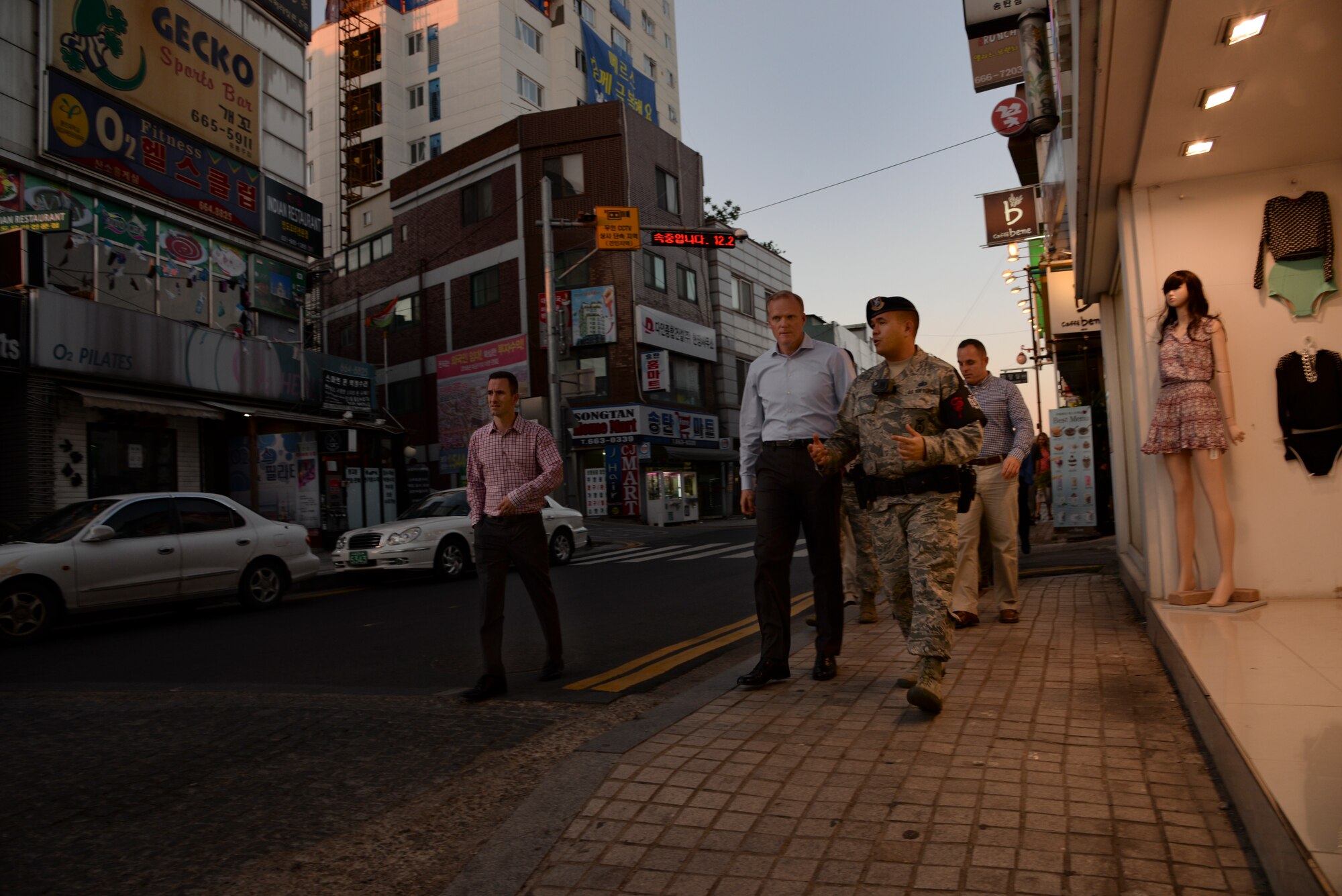 Chief Master Sgt. of the Air Force James Cody, speaks with Tech. Sgt. Markus Mindoro, 51st Security Forces Squadron noncommissioned officer in charge of town patrol, while touring the Songtan Entertainment District July 1, 2015, outside Osan Air Base, Republic of Korea. As the Air Force's highest ranking enlisted Airman, Cody spoke members of town patrol who monitor the streets of the SED during the hours of darkness to ensure the safety of service members and the local community. (U.S. Air Force photo by Staff Sgt. Benjamin Sutton/Released)