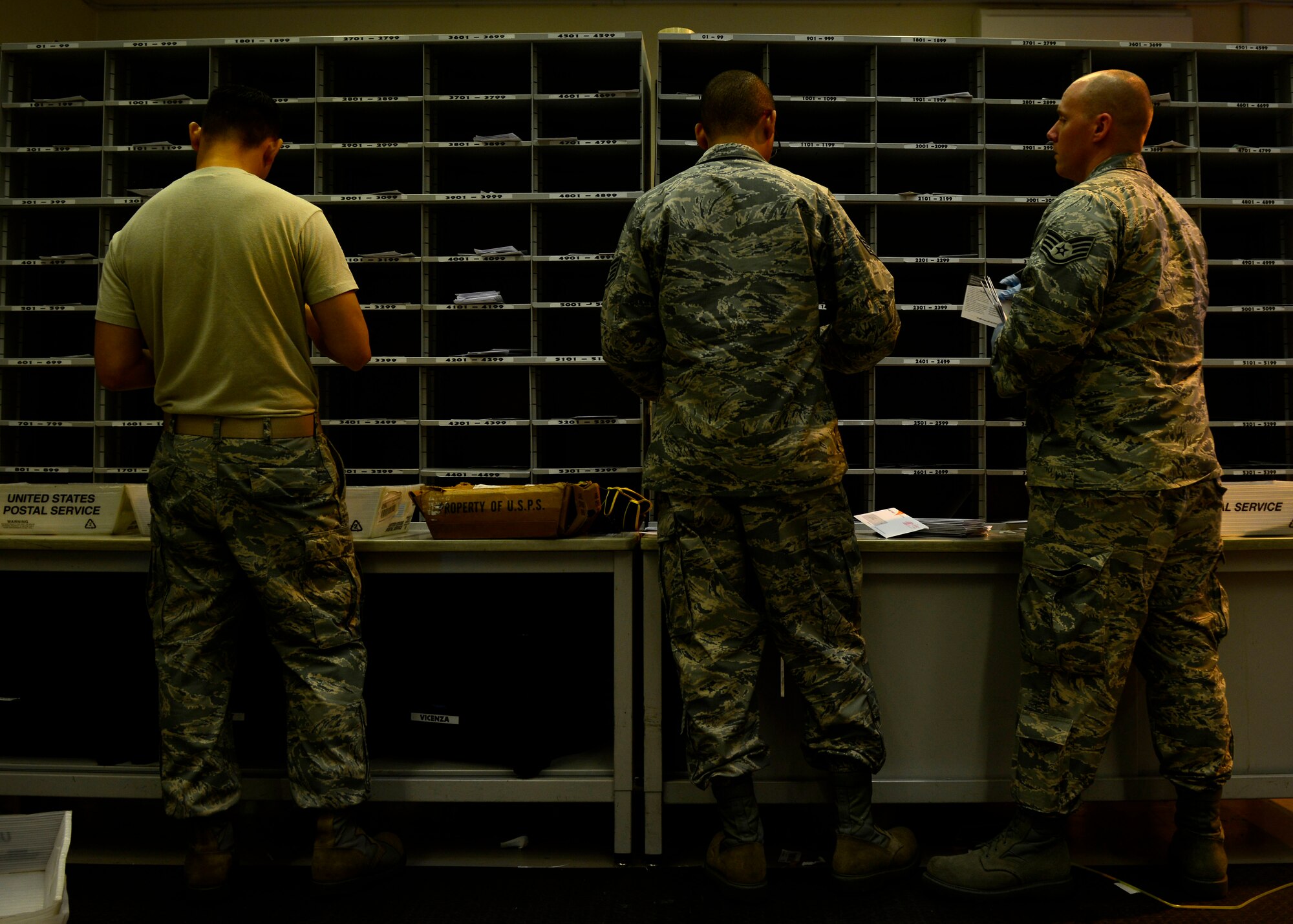 U.S. Air Force Airmen assigned to the 31st Communications Squadron Post Office, sort mail, July 1, 2015, at Aviano Air Base, Italy. The Aviano Post Office received more than 77,000 parcels this year for service members, dependents and civilians assigned to the installation. (U.S. Air Force photo by Senior Airman Areca T. Wilson/Released)