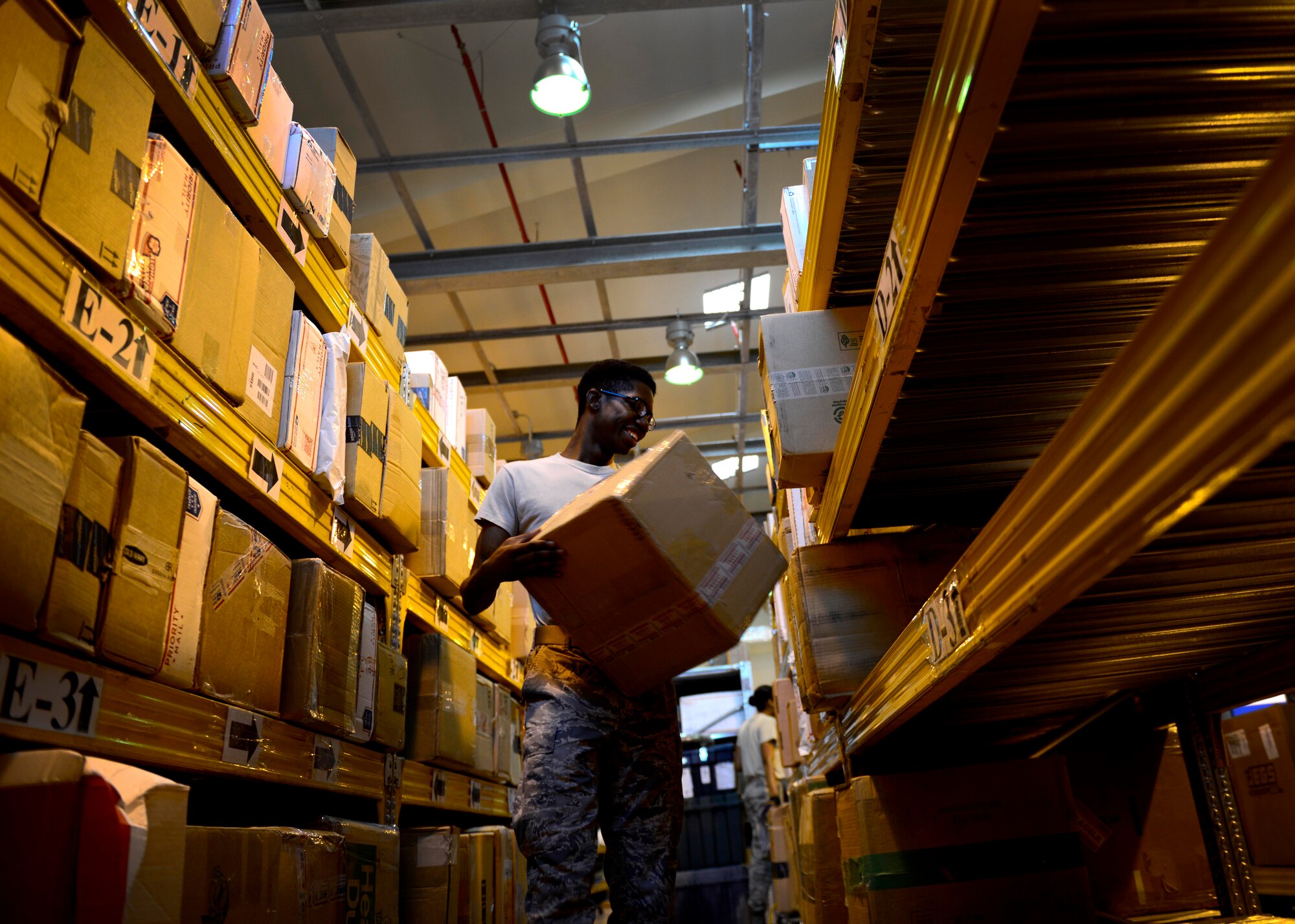 U.S. Air Force Airman 1st Class Kenneth Bell, 31st Communications Squadron postal clerk, sorts inbound mail onto shelves, July 1, 2015, at Aviano Air Base, Italy. If a customer has five or more packages to mail, the post office encourages him or her to make an appointment or visit the post office in the morning. For more information, call 632-7119. (U.S. Air Force photo by Senior Airman Areca T. Wilson/Released)