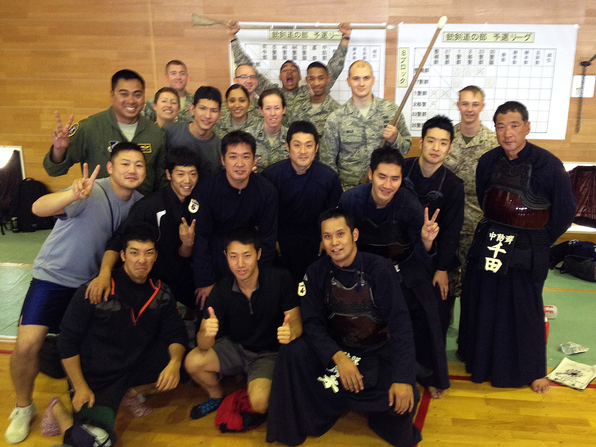 U.S. Air Force Airmen from the 623rd Air Control Flight pose for a photo with Japanese Kendo, Ju Kendo and Kempo tournament participants June 25, 2015, near Iruma Air Base, Japan. The 623rd Air Control Flight "Lightsword" combined with their Japan Air Self-Defense Force counterparts during a temporary deployment to Iruma Air Base, Japan, to strengthen bilateral relations June 22-26. (U.S. Air Force courtesy photo by Lt. Col. Daniel Biehl)