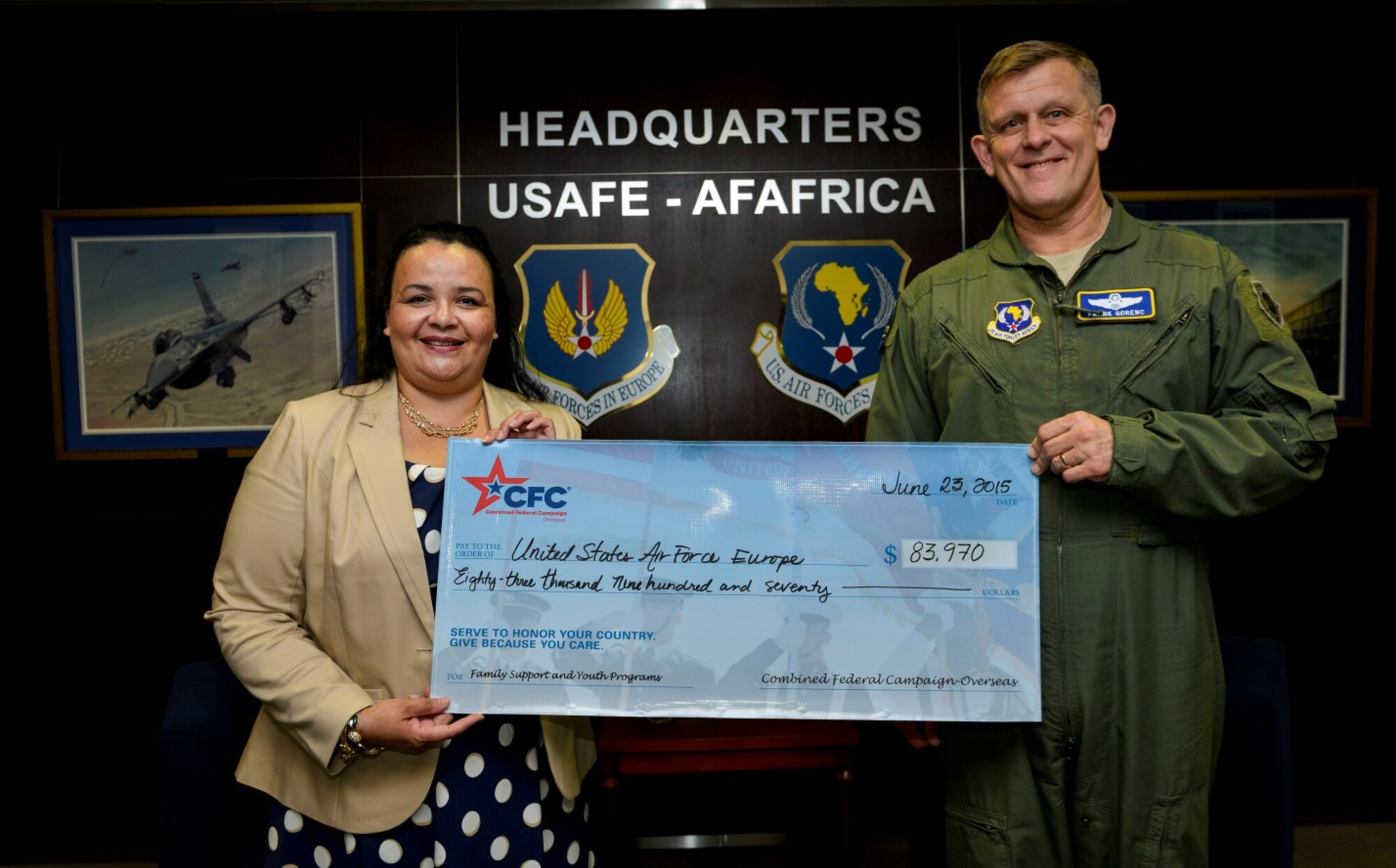 Victoria Adams, Combined Federal Campaign-Overseas executive director, presents a check to Gen. Frank Gorenc, U.S. Air Forces in Europe and Air Forces Africa commander, for funds raised last year June 23, 2015, at Ramstein Air Base, Germany.  The CFC-O holds an annual fundraiser which supports local programs and improves quality of life. (U.S. Air Force photo/Senior Airman Nicole Sikorski) 