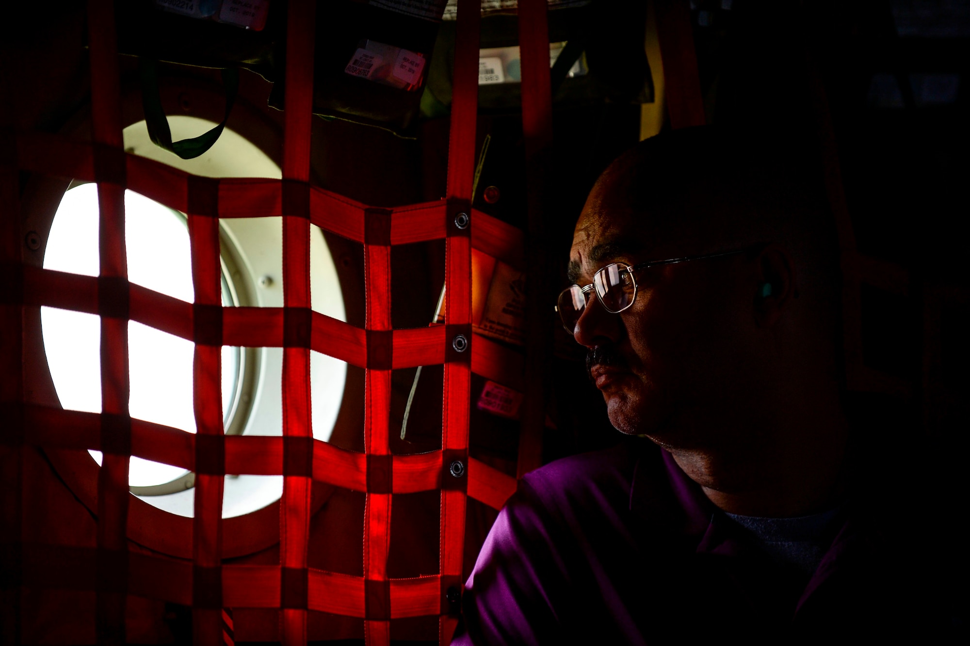 Ray Wilkins, 86th Civil Engineer Group lead personnel technician, looks out the window of a C-130J Super Hercules during an orientation flight for German local nationals June 29, 2015, at Ramstein Air Base, Germany. This orientation flight was a way for Airmen assigned to the 37th Airlift Squadron to show appreciation for those who work in support of Ramstein. (U.S. Air Force photo/Senior Airman Nicole Sikorski)