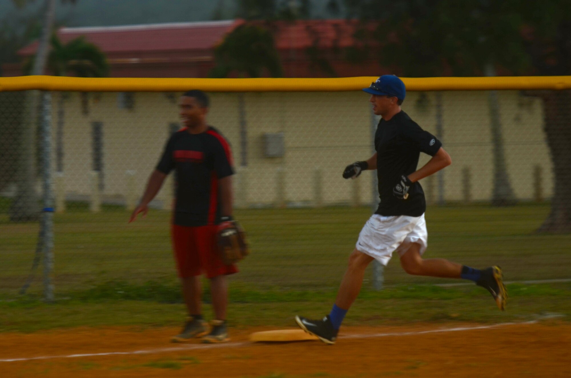 Bo Prather, 36th Medical Operations Squadron, rushes around third base during an intramural softball game between the 36th MDOS and 36th Contracting Squadron July 1, 2015, at Andersen Air Force Base, Guam. The 36th CS won the game with a final score of 19-17.  (U.S. Air Force photo by Airman 1st Class Alexa Ann Henderson/Released)
