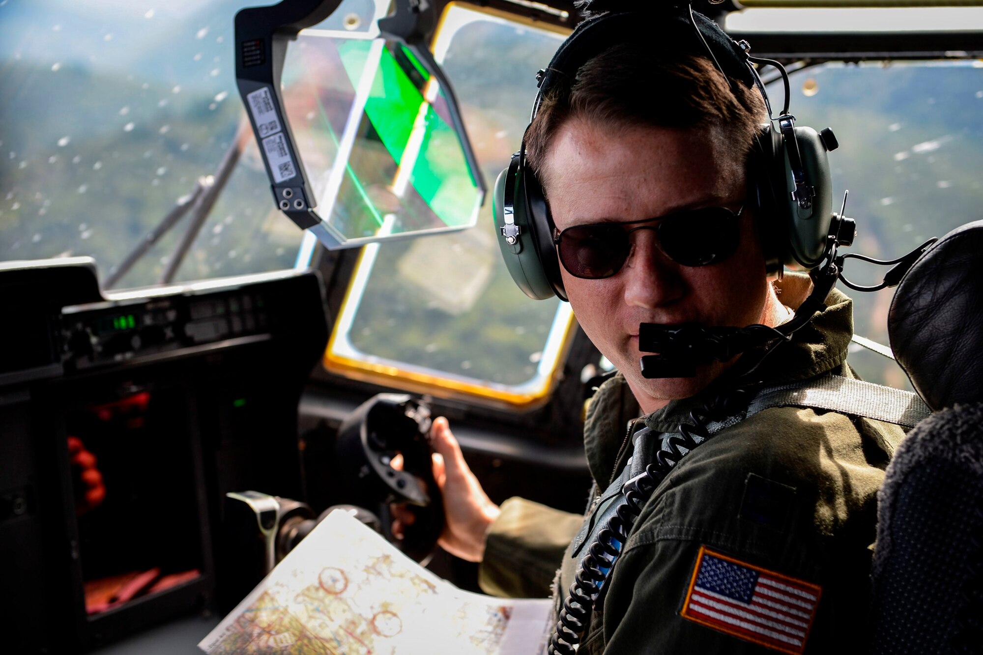 Capt. Jonathan Recor, 37th Airlift Squadron C-130J Super Hercules pilot, oversees passengers during an orientation flight June 29, 2015, at Ramstein Air Base, Germany. More than 20 German locals got the chance to experience the view from the cockpit during the three-hour flight. (U.S. Air Force photo/Senior Airman Nicole Sikorski) 