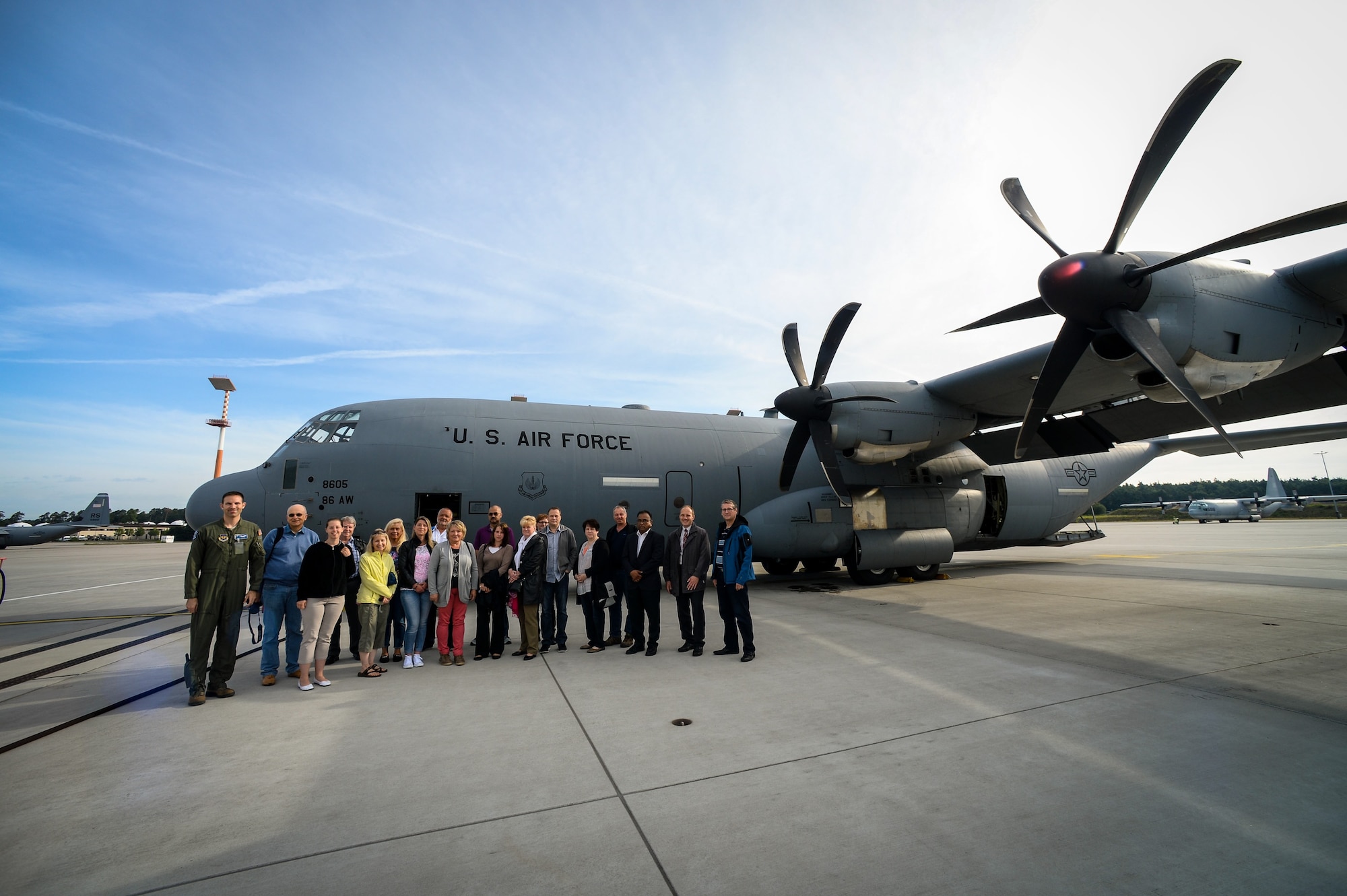 German local nationals, who work at Ramstein Air Base, pose for a group photo in front of a C-130J Super Hercules before an orientation flight June 29, 2015, at Ramstein Air Base, Germany.  With this flight, Airmen from the 37th Airlift Squadron gave a big “thank you” to German locals who support the Ramstein and Air Force mission. (U.S. Air Force photo/Senior Airman Nicole Sikorski) 