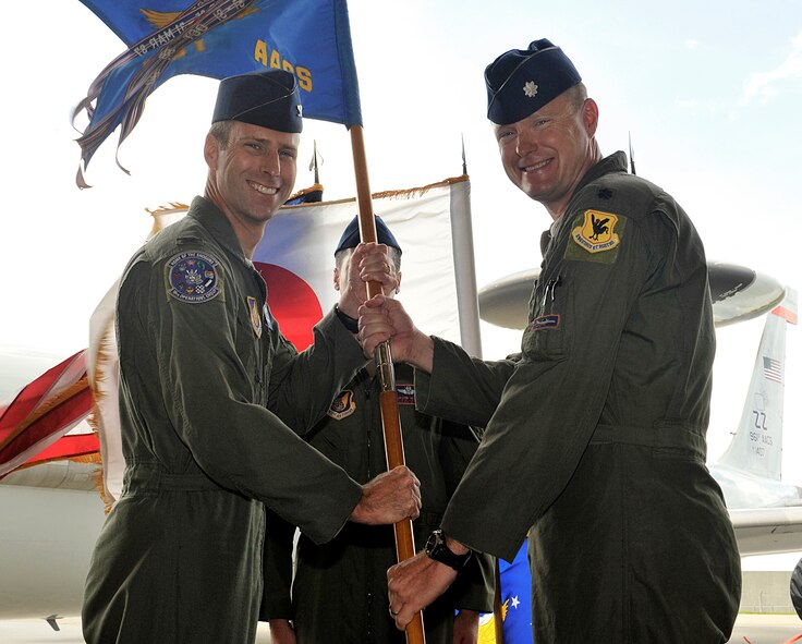 U.S. Air Force Col. David Mineau, 18th Operations Group commander, passes the 961st Airborne Air Control Squadron guidon to Lt. Col. Kyle Anderson, 961st AACS commander, during the squadron's change of command ceremony on Kadena Air Base, Japan, July 2, 2015. The change of command is a traditional military ceremony in which the departing commander assembles the Airmen from the squadron for a presentation to the incoming commander. Anderson was the director of operations for the 961st AACS as well as a command pilot and an evaluator with 3,490 flying hours. He has served in support of Operations Southern Watch, Noble Eagle, and Enduring Freedom, flying over 200 combat and combat support hours. (U.S. Air Force photo by Naoto Anazawa)

