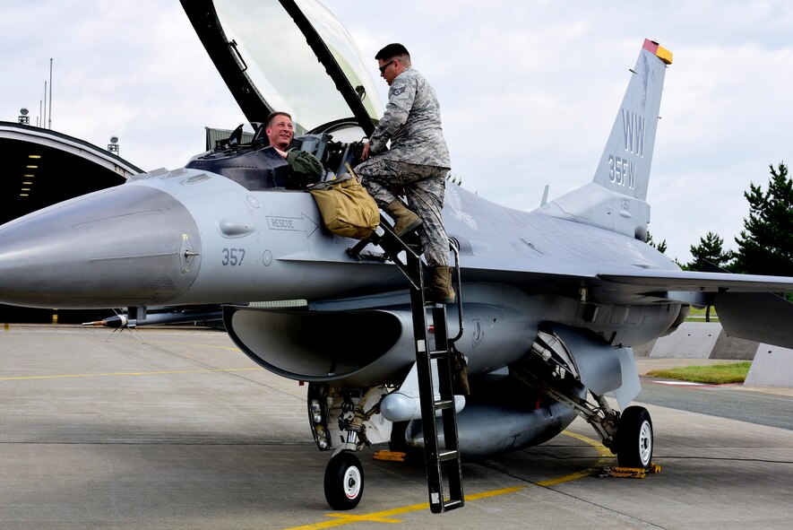 U.S. Air Force Staff Sgt. Cody Puente, 35th Aircraft Maintenance Squadron crew chief, prepares Lt. Gen. John Dolan, U.S. Forces Japan and 5th Air Force commander, for flight at Misawa Air Base, Japan, July 2, 2015. Dolan’s flight in one of the 35th Fighter Wing’s F-16 Fighting Falcons was part of his first visit to Misawa AB after taking command in June. (U.S. Air Force photo by Airman 1st Class Jordyn Fetter/Released)