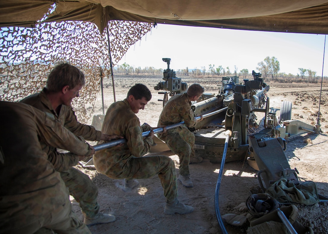 Australian army gunners clean the bore of their M777A2 lightweight 155 mm howitzer after firing in support of a U.S. Marine Corps air assault course on Bradshaw Field Training Area, Northern Territory, Australia, June 29, 2015. The Australian soldiers are assigned to the 101st Battery, 8th/12th Regiment, Royal Australian Artillery.