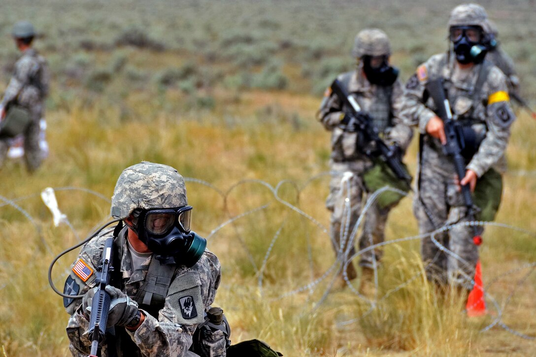 Washington National Guard soldiers wearing protective gas masks provide