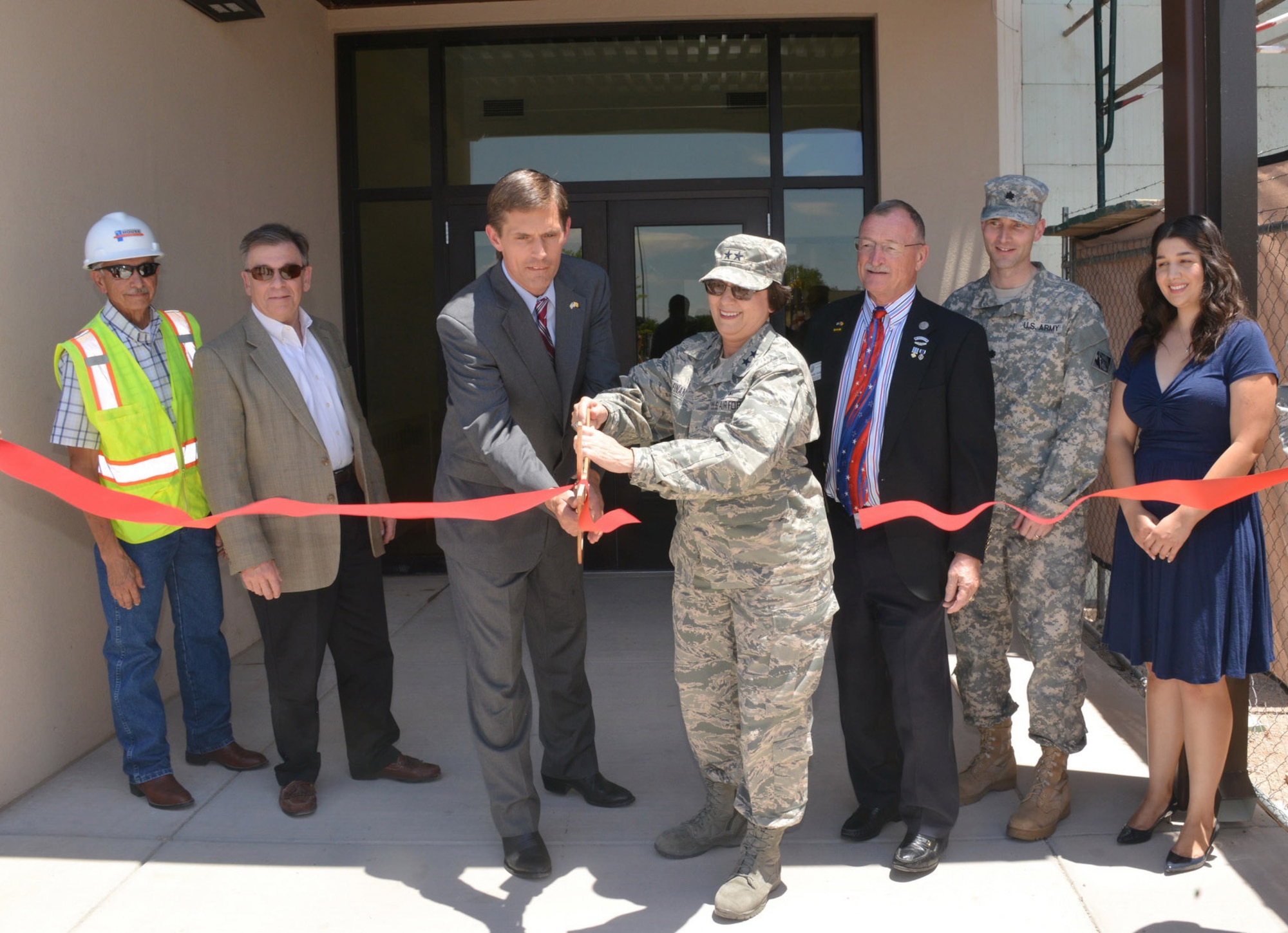 Sen. Martin Heinrich and Maj. Gen. Sandra Finan, commander of the Air Force Nuclear Weapons Center, cut the ribbon at a ceremony introducing a new building at the AFNWC.  The ribbon cutting was for the recently completed “phase one” of the expansion, a $29 million, 56,000-square-foot workspace that will soon serve as the workplace for 350 people. It will house the AFNWC’s Sustainment and Technical Integration Center and members of the Nuclear Technology and Interagency Directorate.(Photo by Dennis Carlson)